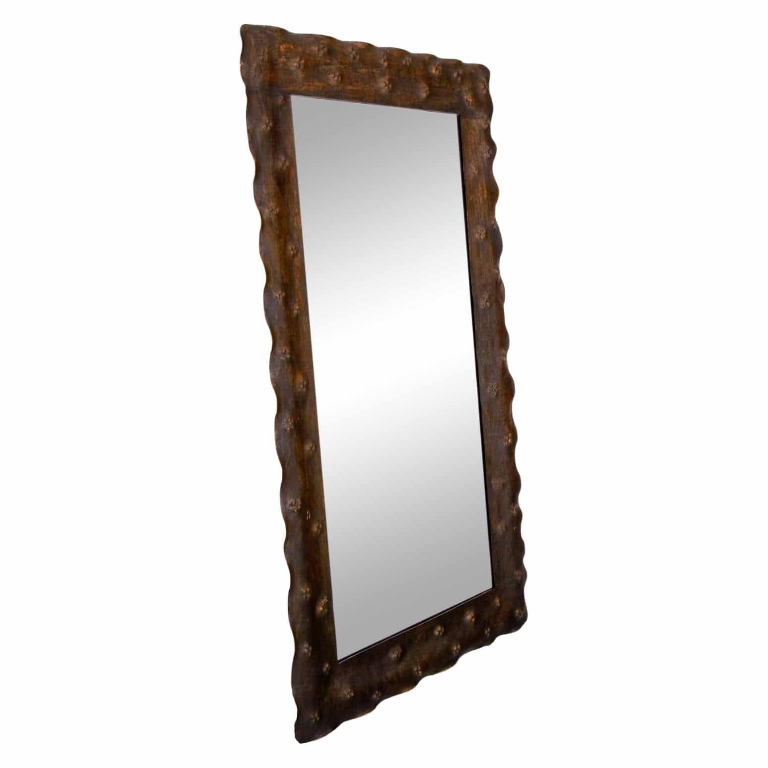 A dark-brown, vintage Mid-Century Modern Italian rectangular wall mirror made of hand crafted metal, in good condition. The original mirrored glass is supported, halted by the hammered and slightly wavy frame. Wear consistent with age and use. circa