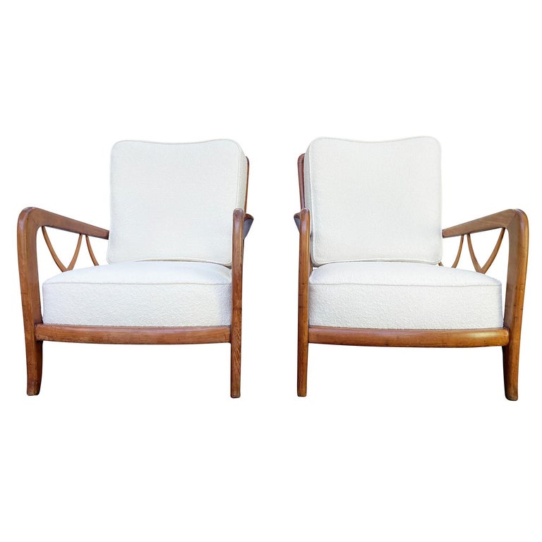 A dark-brown, vintage Mid-Century Modern Italian pair of lounge chairs made of hand carved polished Cherrywood, designed by Paolo Buffa in good condition. The crosses are made of hand carved Maplewood. The backrest and the sides of the armchairs are