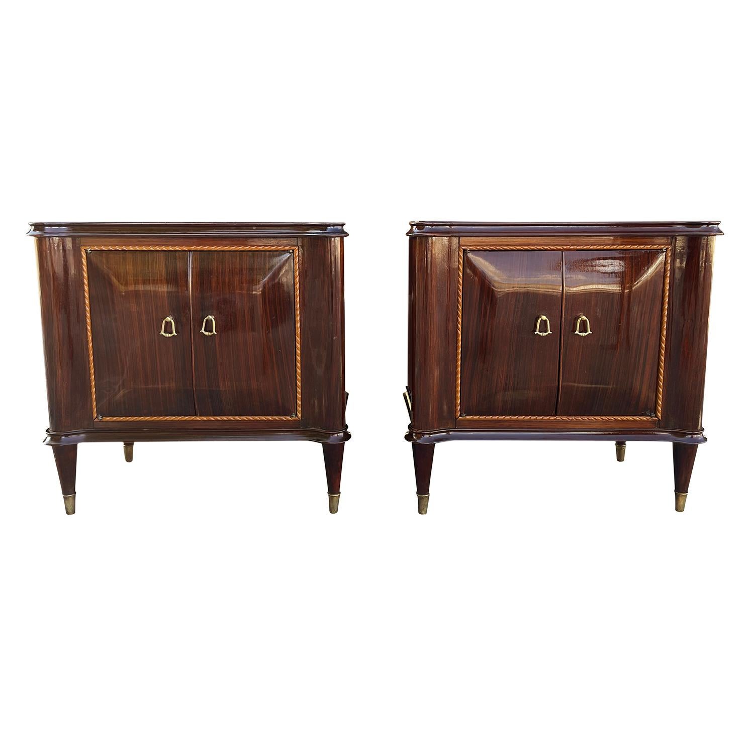 A vintage Mid-Century modern Italian pair of bed side tables made of hand crafted polished, partly veneered Mahogany, designed by Paolo Buffa in good condition. The nightstands are composed with a colored, slightly smoked glass top and two small