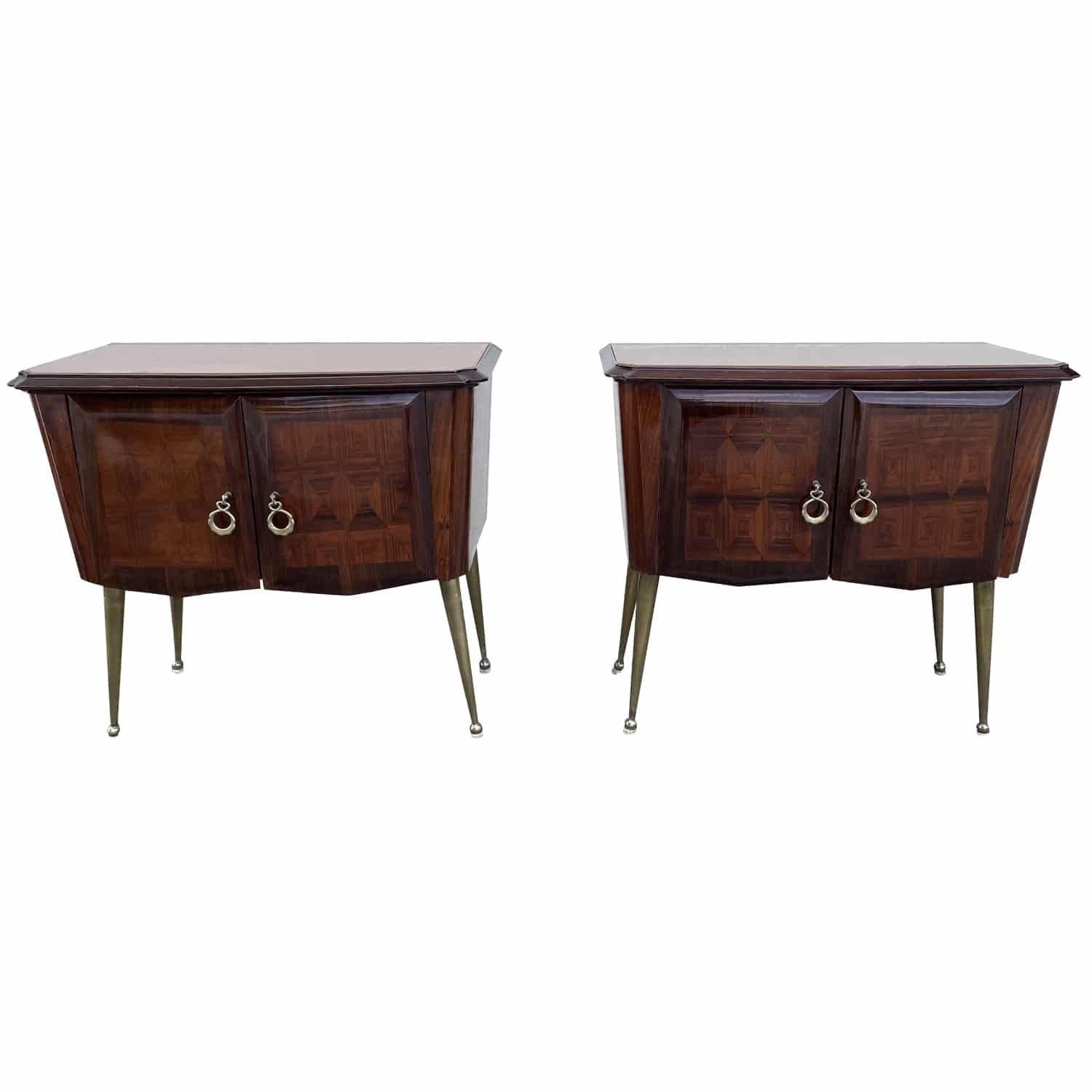 A dark-brown, vintage Mid-Century Modern Italian pair of nightstands, bedside tables made of hand crafted polished Rosewood with two small doors composed with detailed brass pulls, handles in good condition. The side tables are supported by four