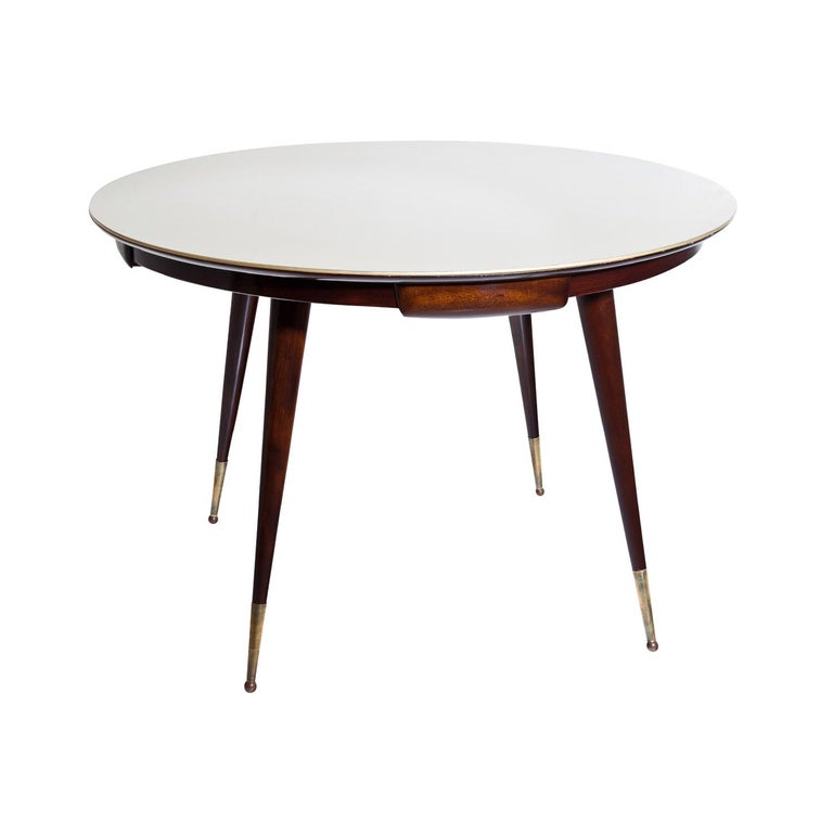 A dark-brown, vintage Mid-Century Modern Italian game table with a gold underlaid glass top, made of hand crafted polished Rosewood, designed by Vittorio Dassi in good condition. The narrow frame of the side table is consisting four small drawers,