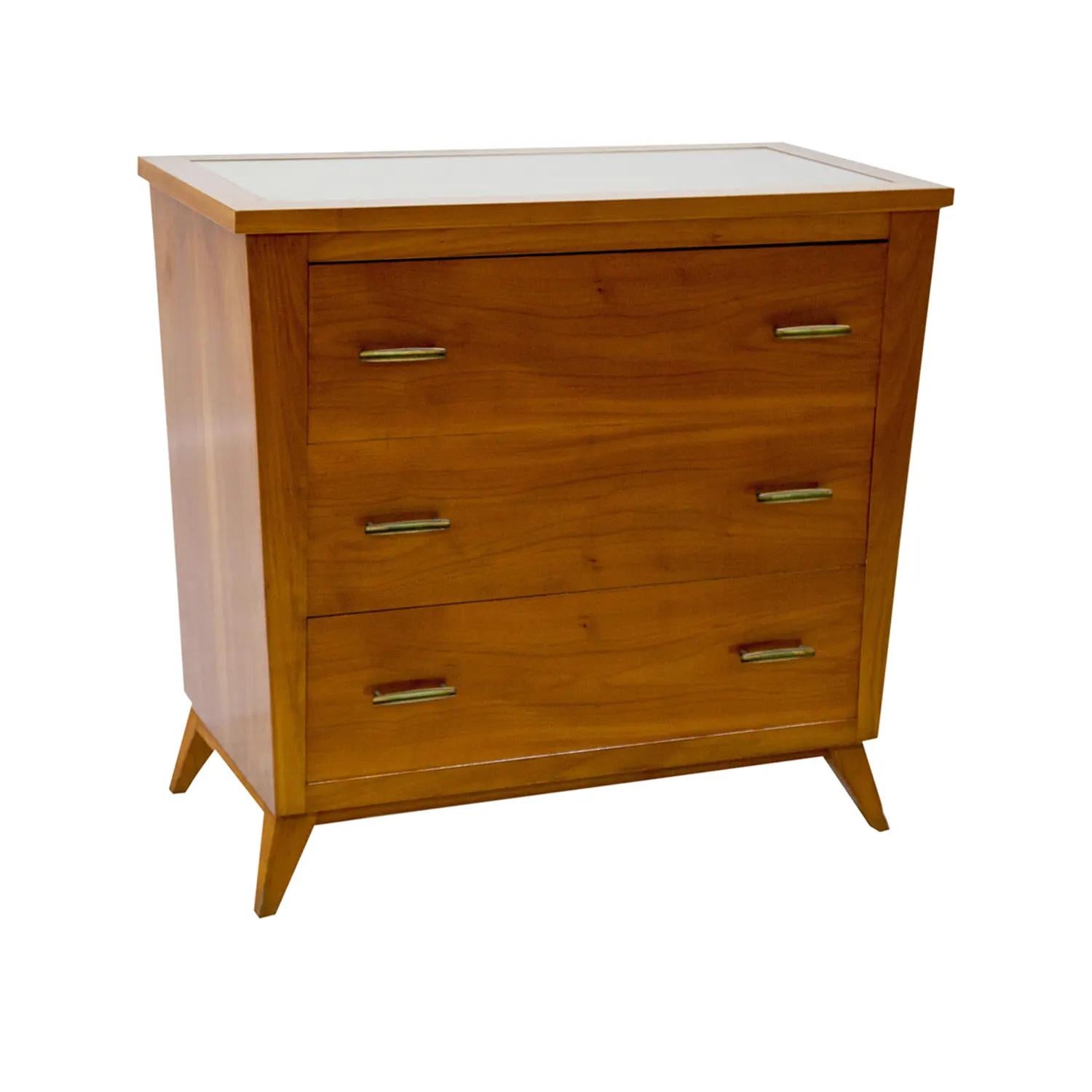 A light-brown, vintage Mid-Century Modern Italian chest with a trapezoidal body and an imbedded glass top, made of hand carved veneered Cherrywood in good condition. The small rectangular cabinet, cupboard is composed with three drawers, consisting