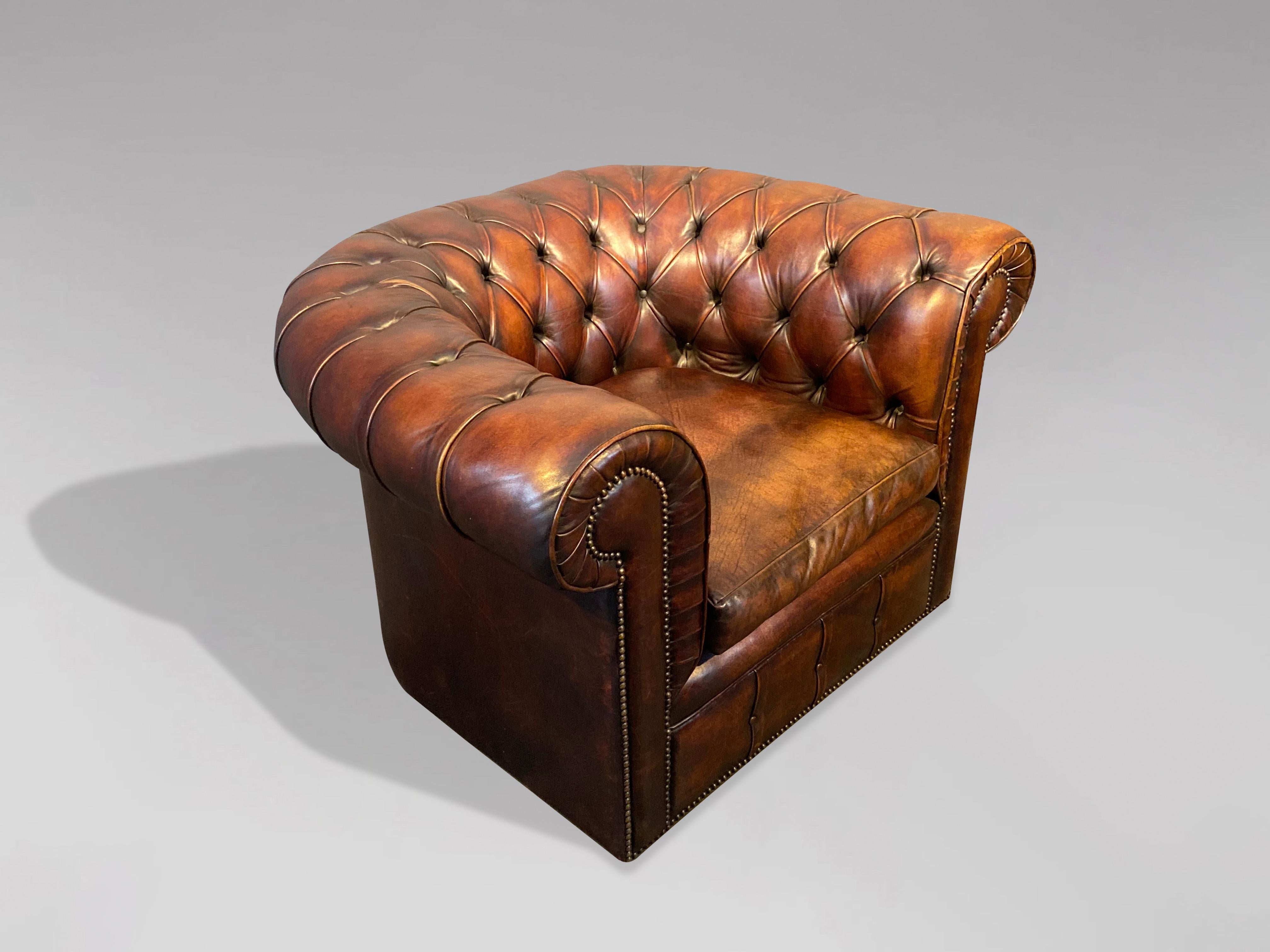 A good quality early 20th century, brown leather club armchair chesterfield. Original hand dyed golden brown leather hide that has been cleaned and polished giving a lovely soft and sumptuous feel to the quality leather. This chesterfield is horse