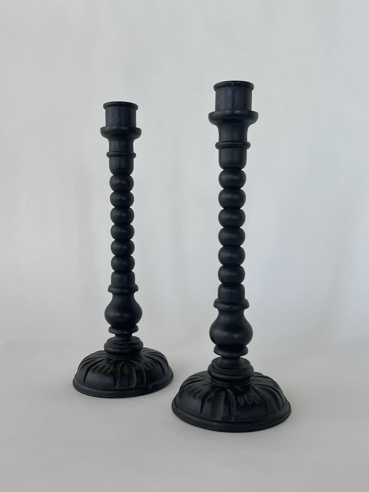 20th century Brutalist candle stick holders in a tall shape with a dark black paint. The set ready to be displayed in your home.