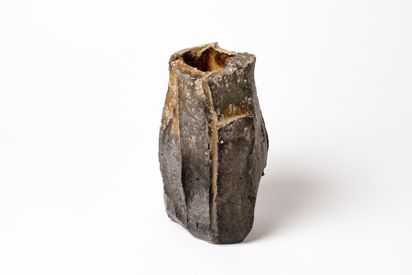 Eric Astoul

20th century Brutalist stoneware ceramic vase by the French artist.

Realized in 1990, signed at the base.

Originals browns and blacks wood kiln colors effects.

Measures: Height 22cm, large 15cm, depth 13cm.