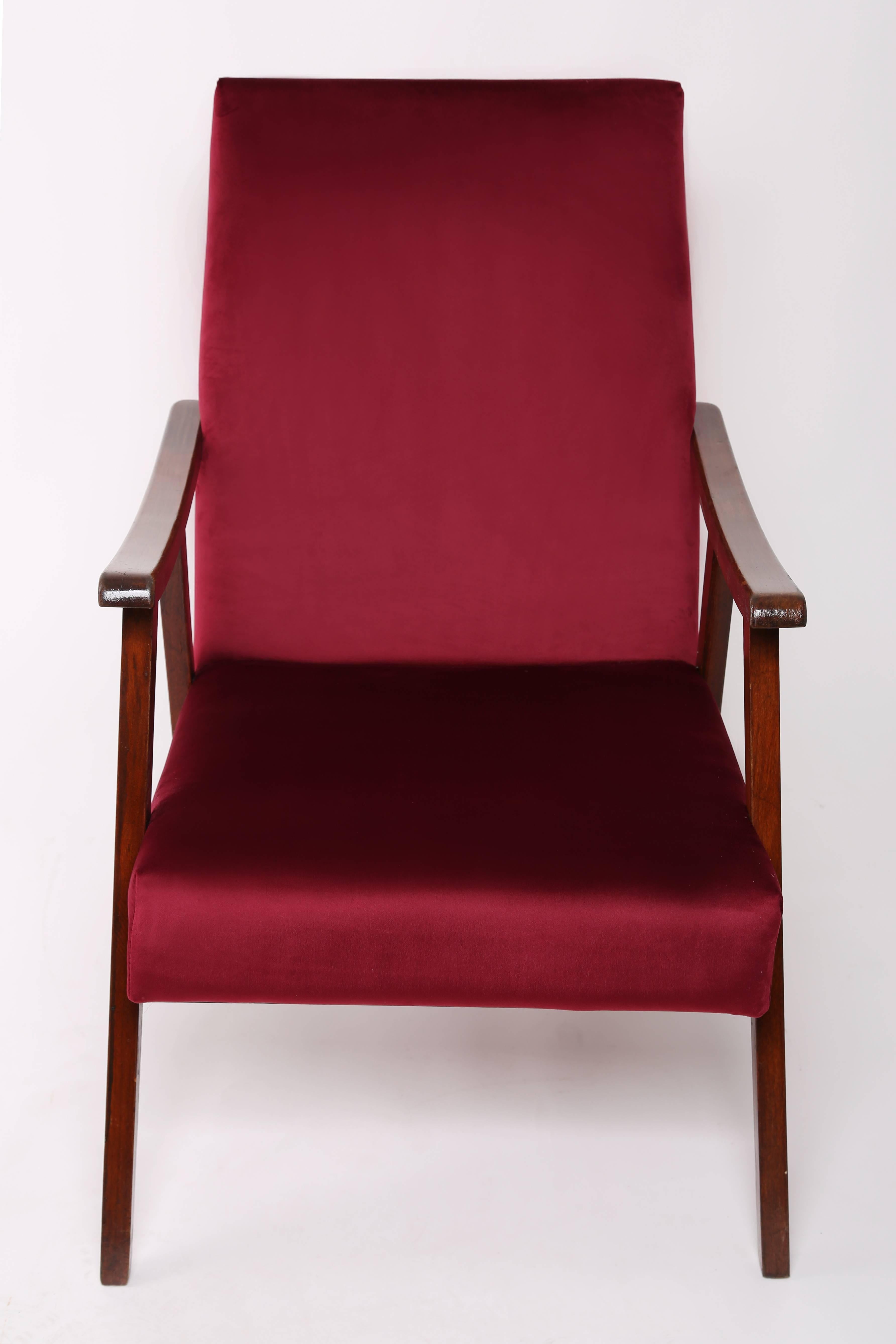 The armchair produced in the times of the PRL, we estimate the 1960s. Furniture after a full carpentry and upholstery renovation. The seat and backrest are covered with high quality velor with a deep maroon color. The armchair will work as an accent