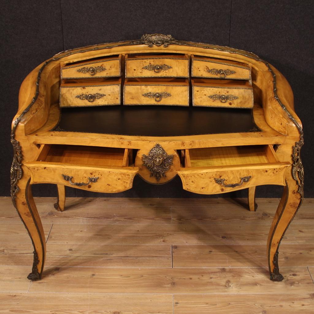 Elegant French writing desk from the second half of the 20th century. Wavy and rounded furniture in burl richly adorned with patinated and chiselled bronze and brass. Napoleon III style writing table built in a single block, finished as a