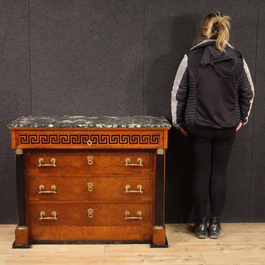 Italian chest of drawers from the second half of the 20th century. Empire style furniture veneered in burl and ebonized wood of beautiful lines and pleasant furnishings. Commode with four large drawers and original marble top of good size and