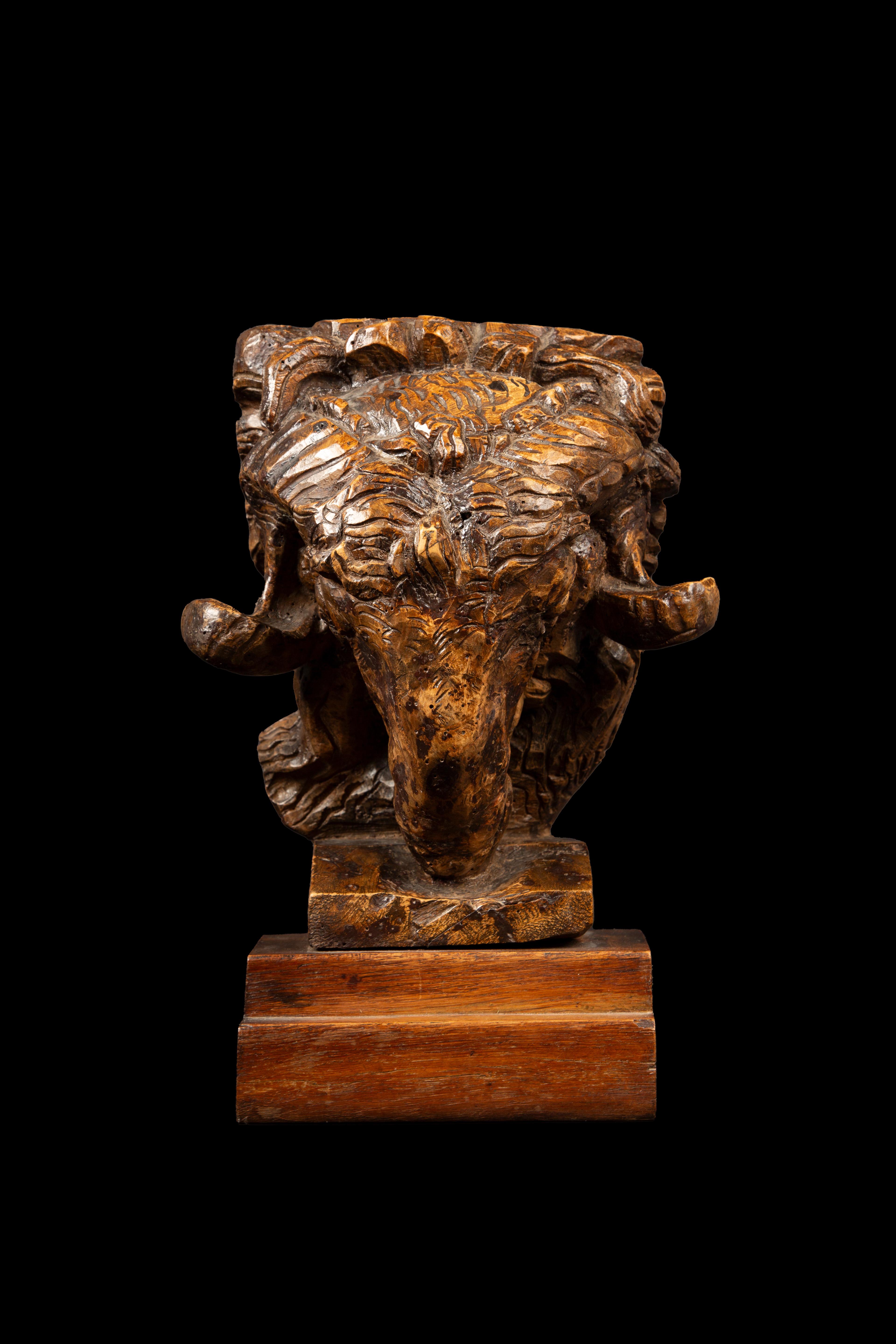 This stunning burl wood sculpture of a ram's head, crafted by renowned Swiss sculptor Edwin Bucher, showcases the artist's mastery of form and texture. Born in Lucerne, Switzerland, on March 14, 1879, Bucher initially studied art and craftsmanship