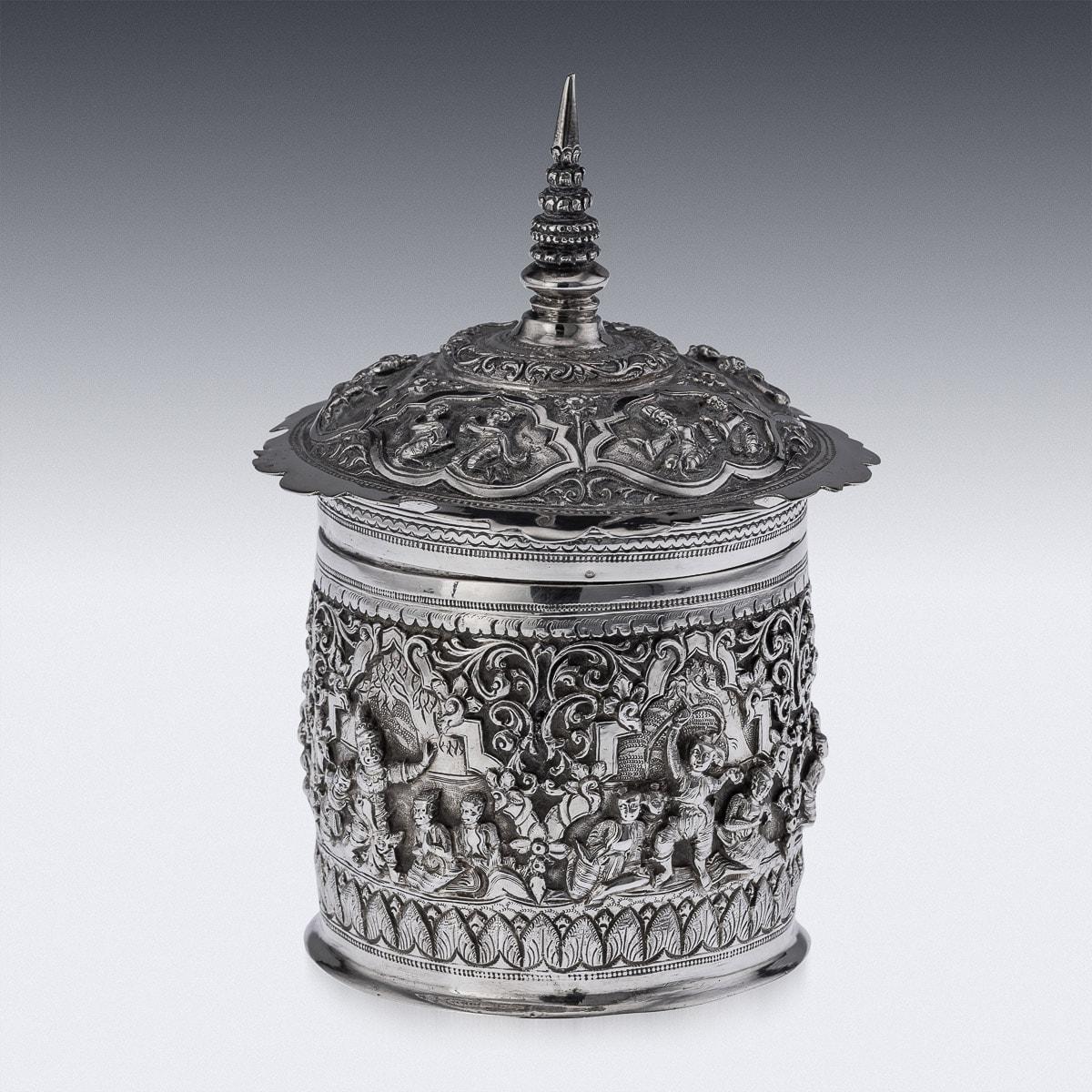 Antique early-20th Century Burmese solid silver betel box, highly-decorative, repousse' decorated in high relief depicting different traditional scenes from the Burmese mythology, showing very detailed figures set against a chiselled matted
