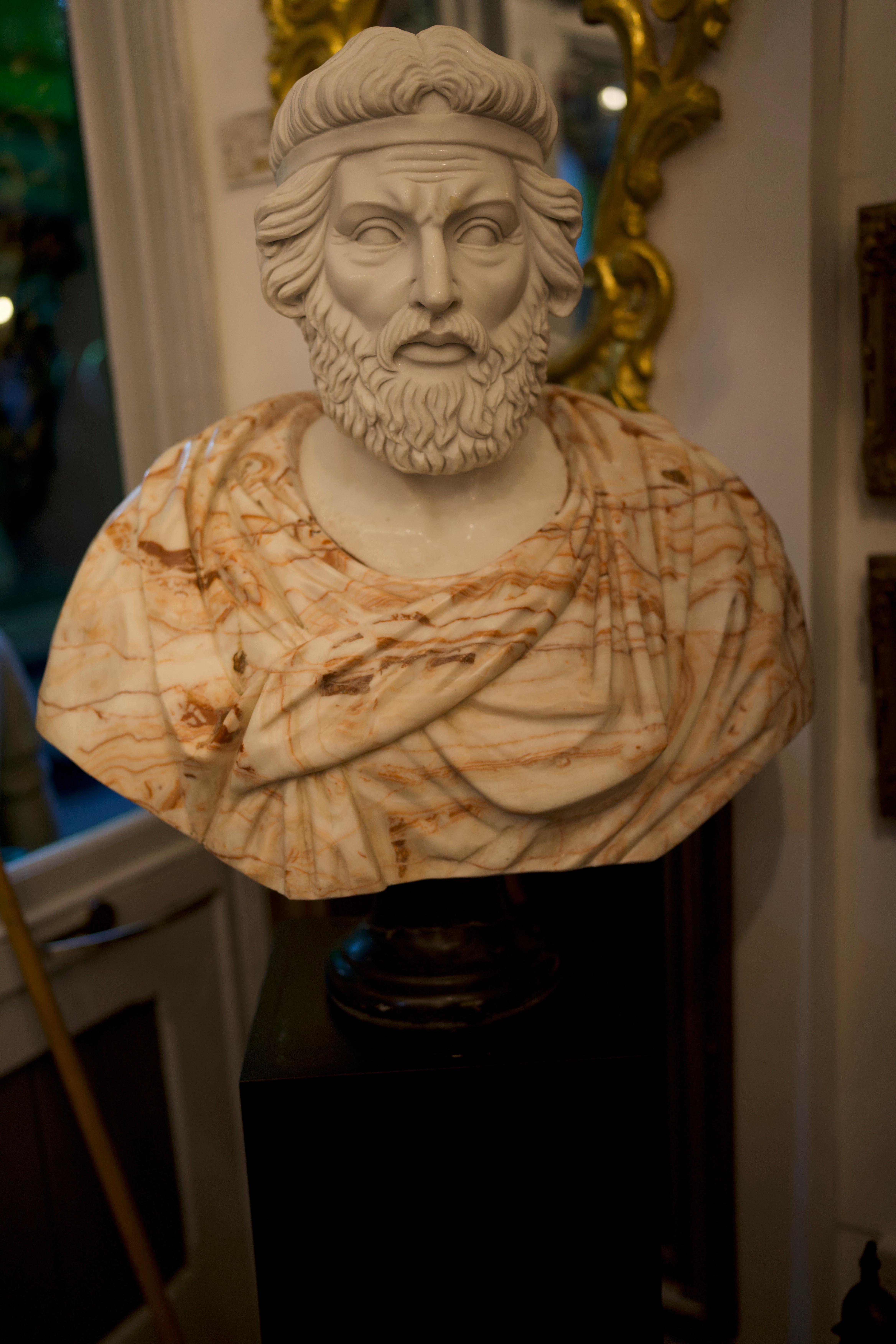 A large 20th Century Bust of Roman Hand Carved in Carrara White and Alicante red marble. Hand carved by craftsmen using Carrara white marble for the head and Alicante red for the toga, where the white veins give movement and realism to the cloth.