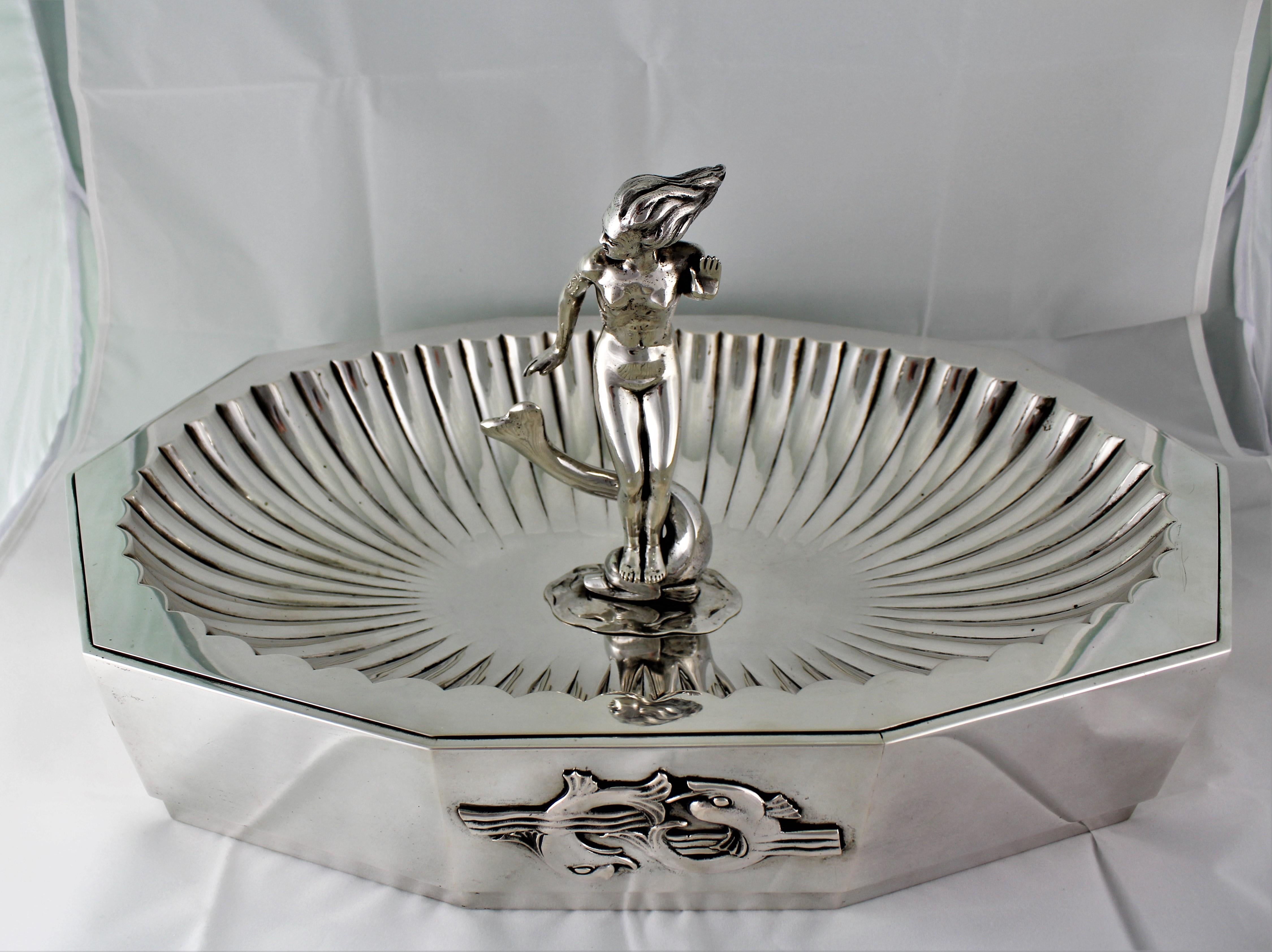 Exceptional handcrafted Art Deco silver centrepiece by the master Italian silversmith Arrigo Finzi.

Designed to honour a friend who died in WWI. That friend was Antonio Sant'Elia, a renowned futuristic architect from Milan.
The friendship