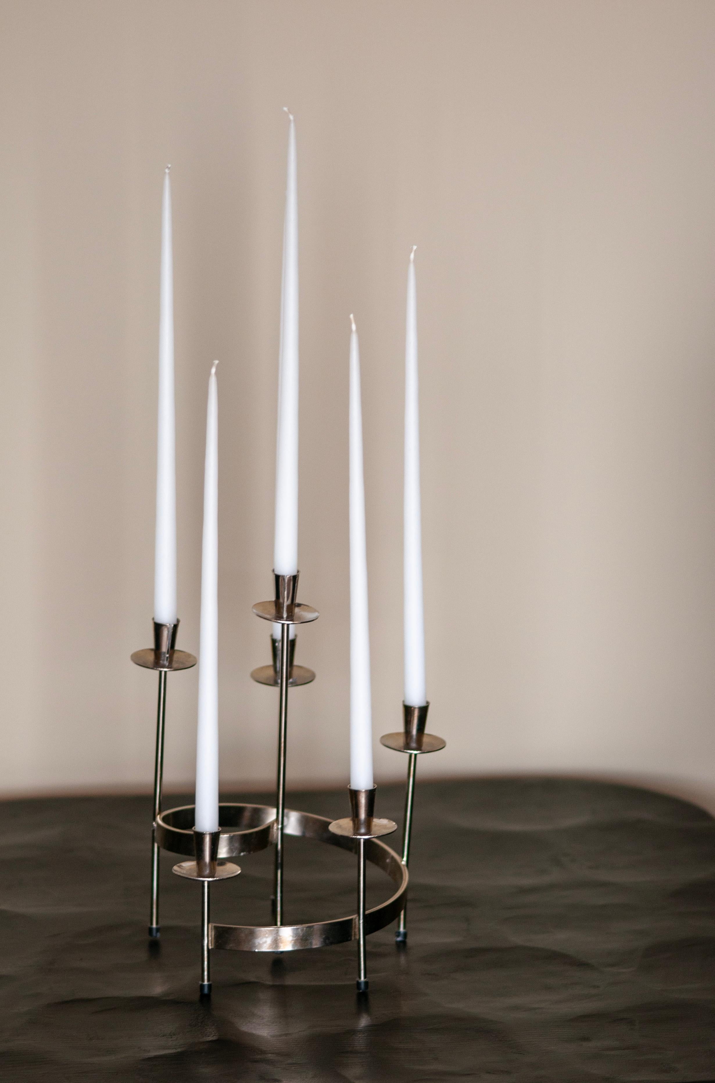 Presenting a delightful round, vintage Mid-Century modern Swedish candlestick, exquisitely handcrafted from white metal. This elegant piece was designed by the renowned Gunnar Ander and skillfully produced by Ystad-Metall, showcasing its impeccable