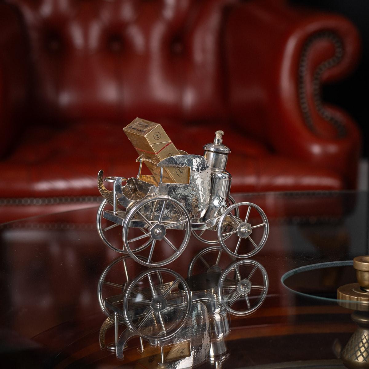 Antique early 20th Century Victorian novelty silver plated table lighter. Made in the shape of a horses carriage, this table lighter features an area in the saloon to place your cigarettes and a small vessel which allows a flame to burn from the