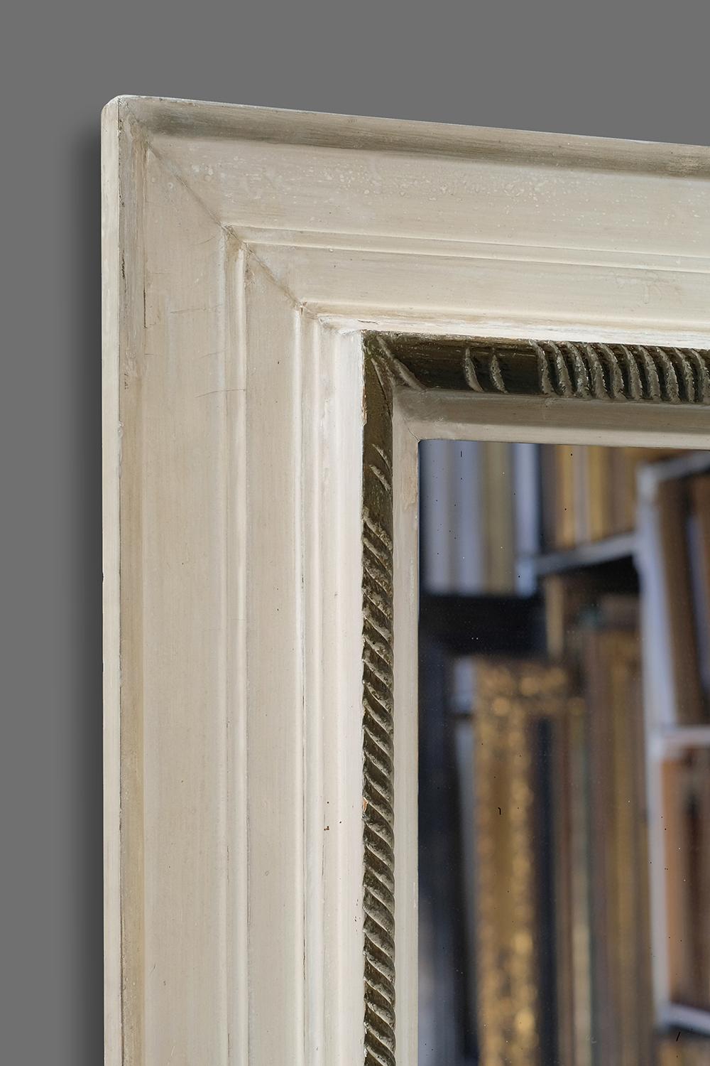 This is a striking 1st quarter 20th century hand carved French artist's frame. It has an architrave profile with torus and a carved centered wave molding adjacent to sight edge. The frame retains its original white paint and stained rail. Further