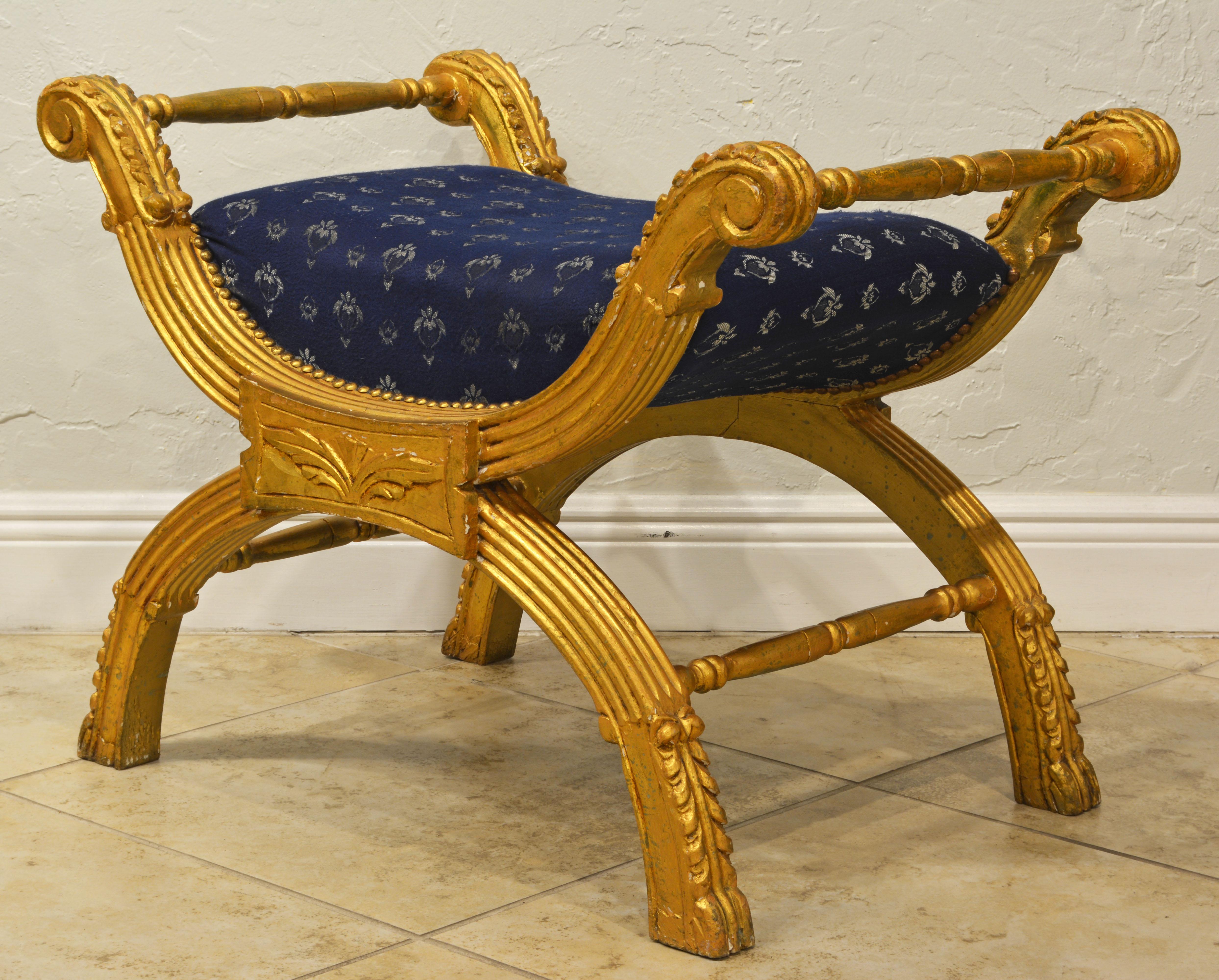 Carved in the classical fashion this Italian giltwood Curule style bench is upholstered and covered with a tasteful fabric. It likely dates to the late 20th century.