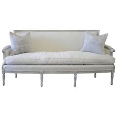 Antique 20th Century Carved Louis XVI Style Painted French Sofa Upholstered in Linen