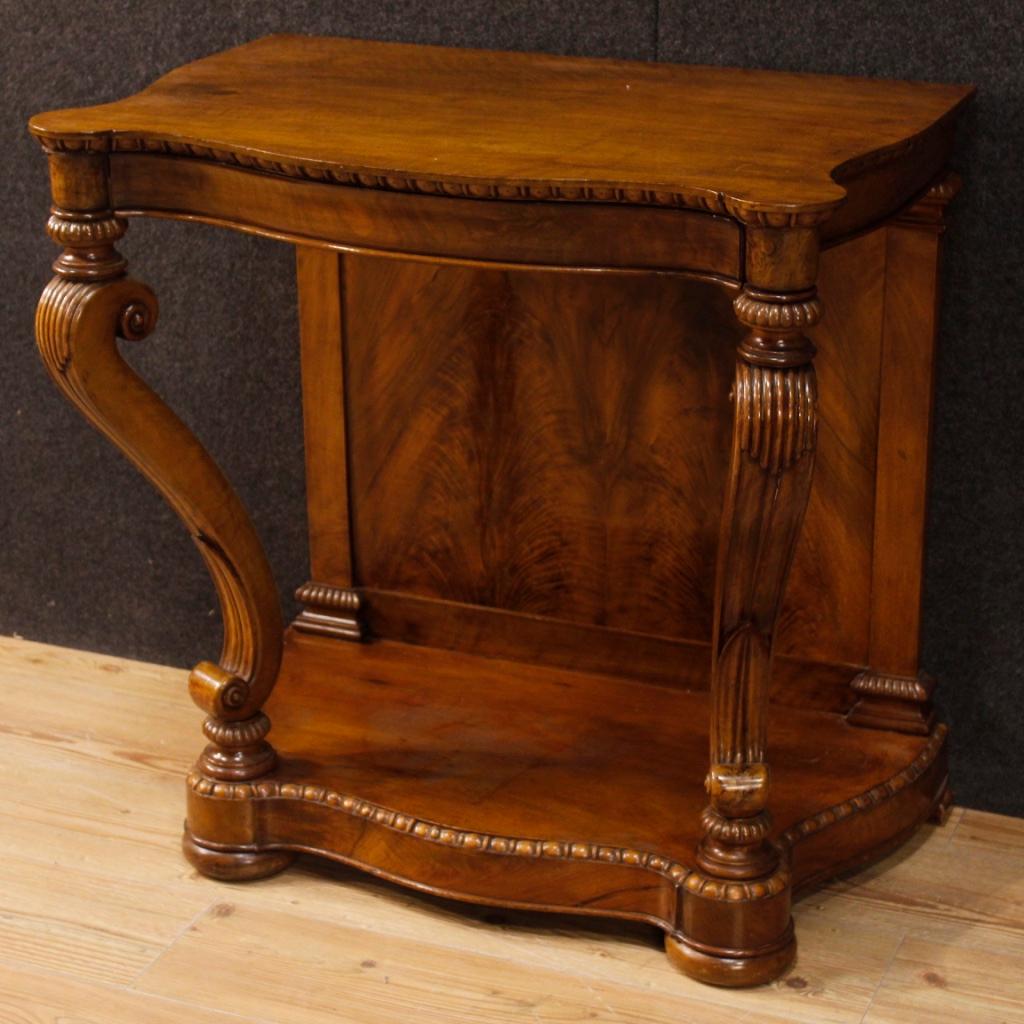 Small French writing desk from the first half of the 20th century. Furniture of excellent quality and proportion pleasantly carved in walnut. Writing desk with wooden top in character with a frontal drawer. Furniture that can also be used as a wall