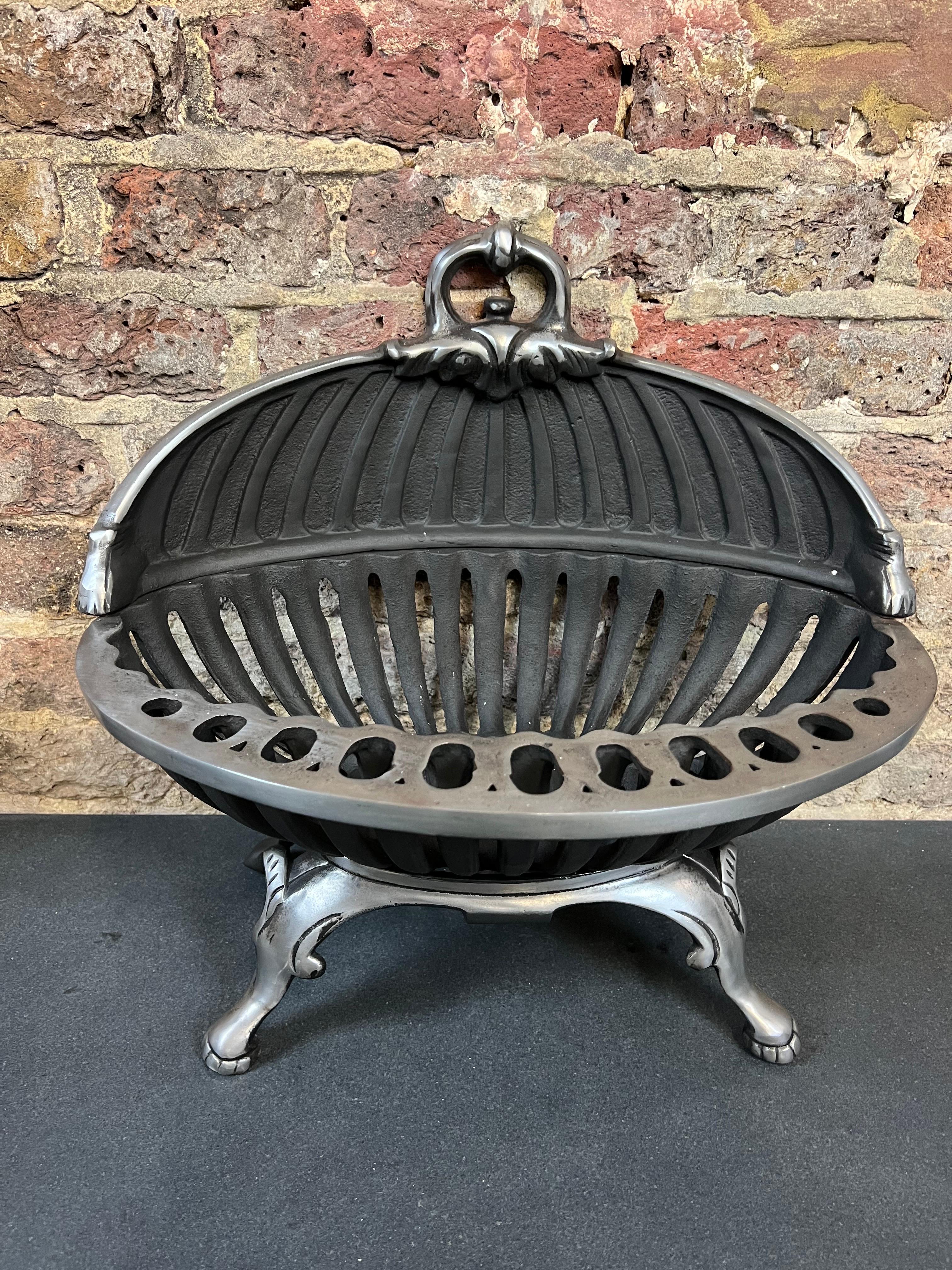 20th century cast-iron fireplace basket.
This Chestnut slotted fire grate has decorative paws and is in a burnished (polished iron) finish. It has a decorative Handel at the top which makes it easy to move when required.

Dimensions:
Width 18