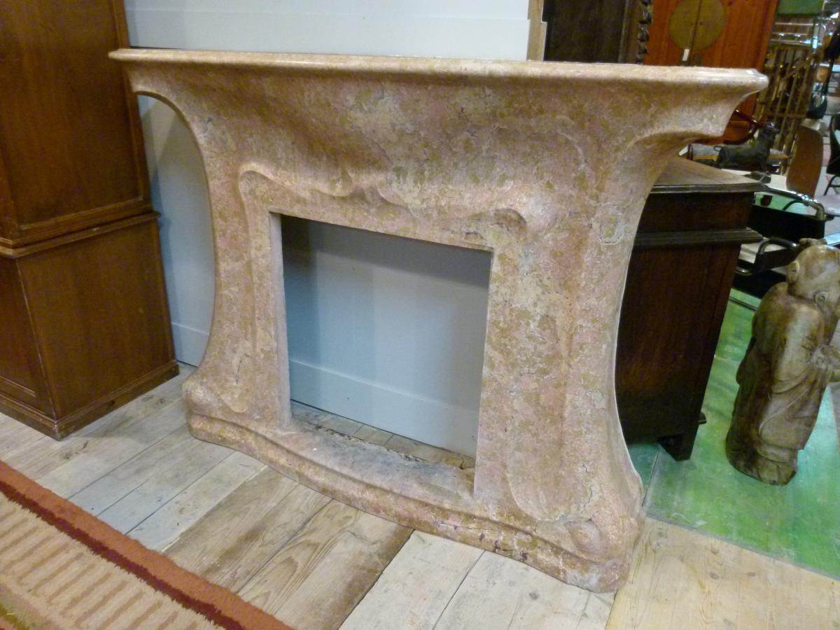 Art Nouveau fireplace with a light rosa marble. 
This elegant fireplace was located in a noble house in Catalonian, Spain.

Measurements:
Fire: 59 x 65 cm
Fireplace: 146 x 37 x 113 cm.
 