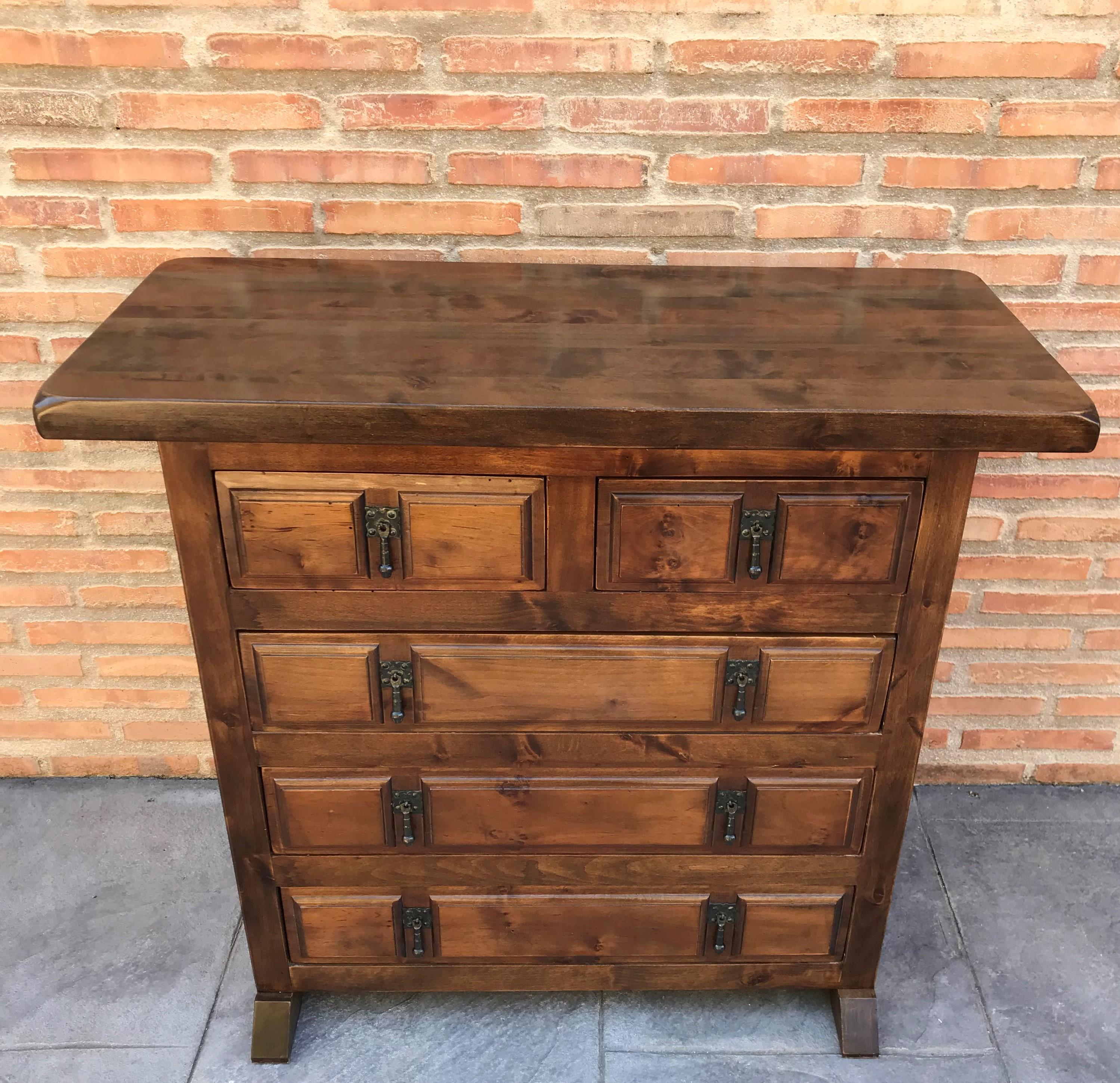 20th century Catalan Spanish carved walnut chest of drawers, highboy or console
Country Provincial Chiffoniere was fashioned from solid walnut and features five drawers carved with charming detail and fitted with unusually intricate cast brass