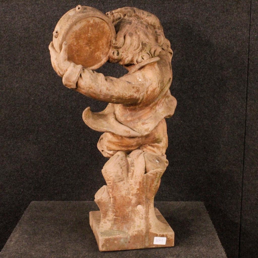 French sculpture from 20th century. Artwork depicting a dancing child with a tambourine in cement. Object of considerable weight in beautiful patina, dyed terracotta. Sculpture that can be positioned both inside and outside the house. With some