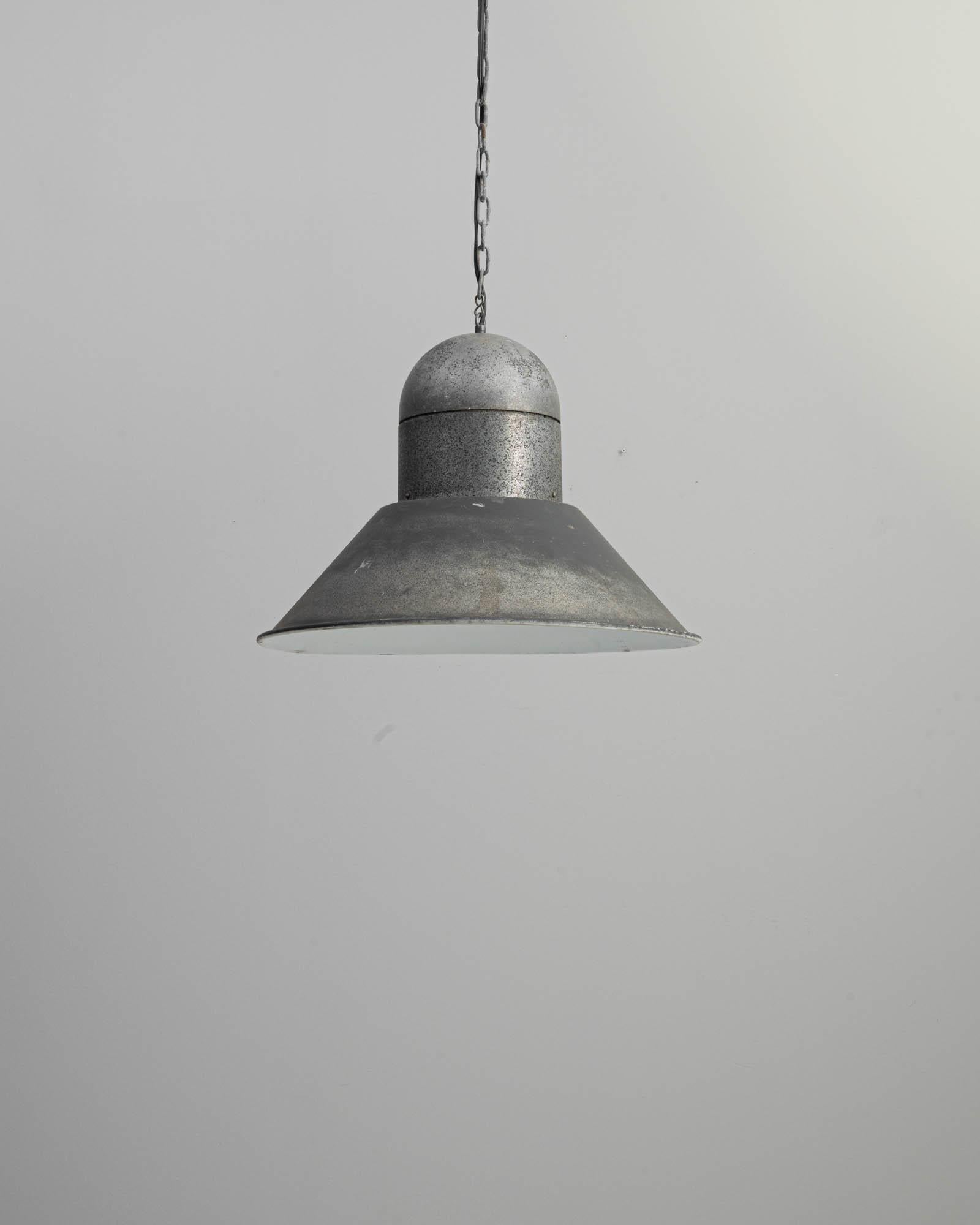 The simple, graphic form of this vintage pendant lamp makes it an Industrial find to treasure. Made in Central Europe in the 20th century, the streamlined dome of the pendant holder is counterbalanced by the wide flare of the circular shade. The
