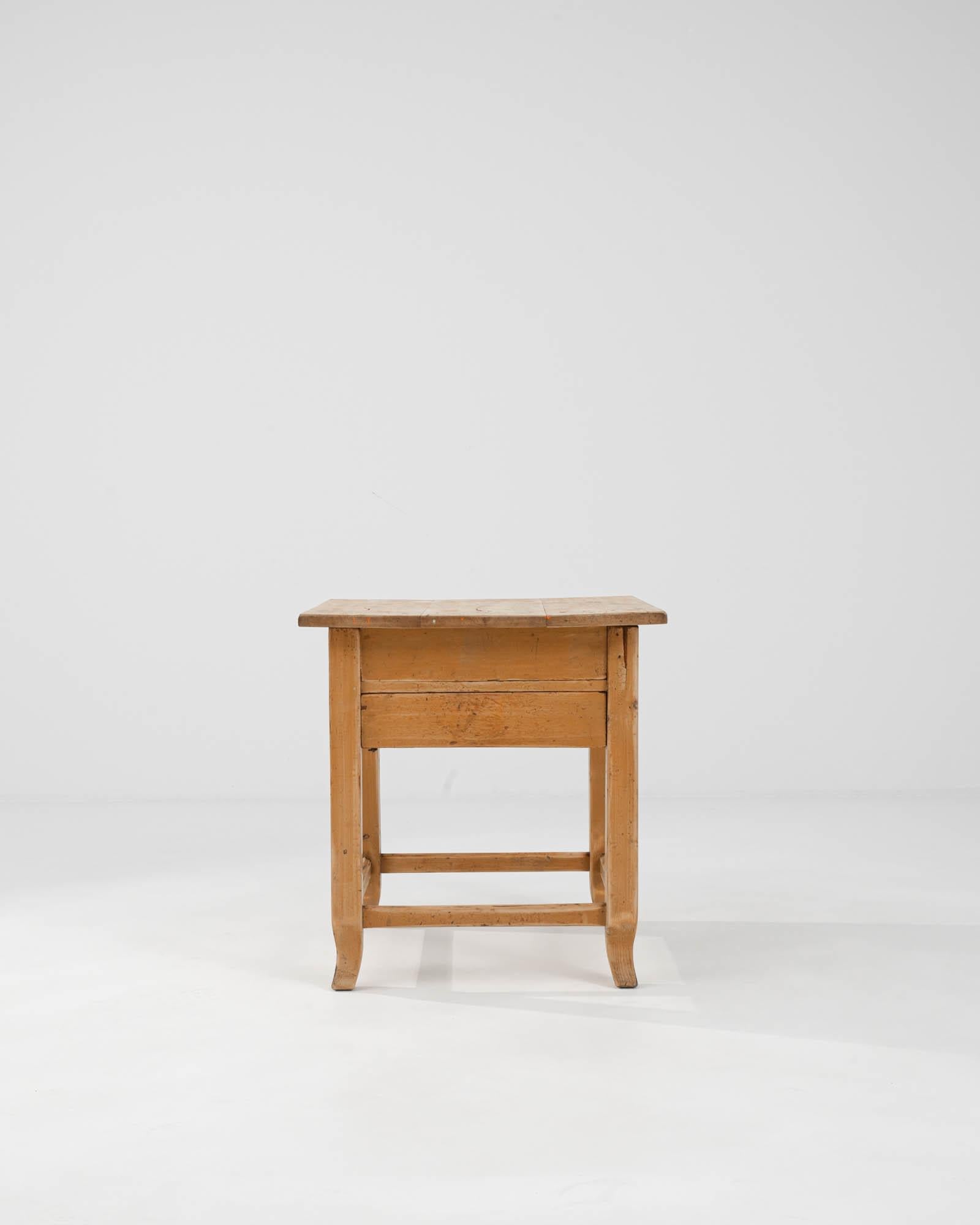 Discover the timeless allure of this 20th Century Central European Wooden Side Table, a piece that carries the weight of history with a simple, yet profoundly versatile design. Originating from the early 1900s, this side table exudes rustic charm