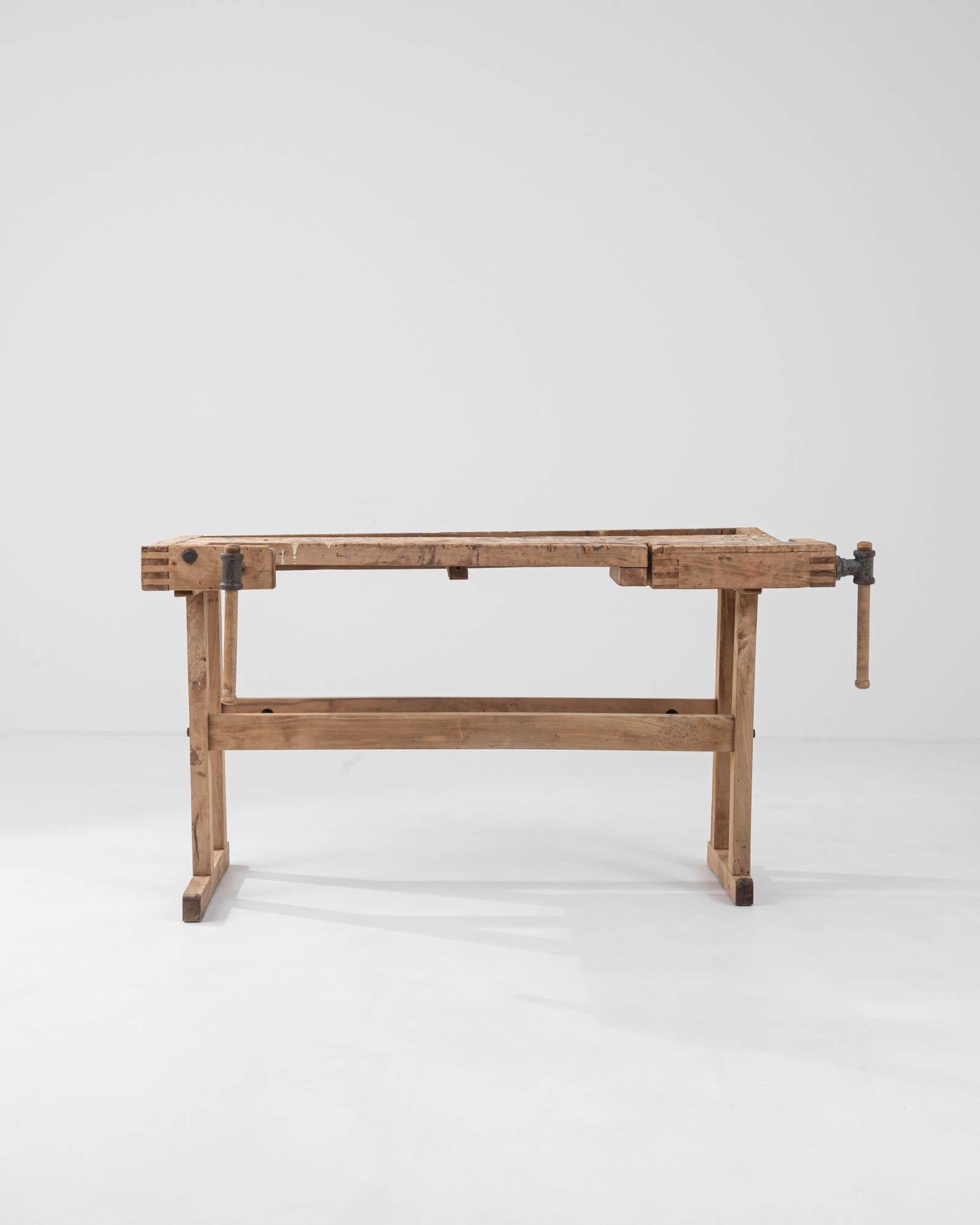 A vintage Central European wooden work table. Constructed from stout wooden beams, crafted with the owner’s livelihood in mind. This ultimate sturdy table’s newest craft is turning function into style. Worn and loved, the details in its