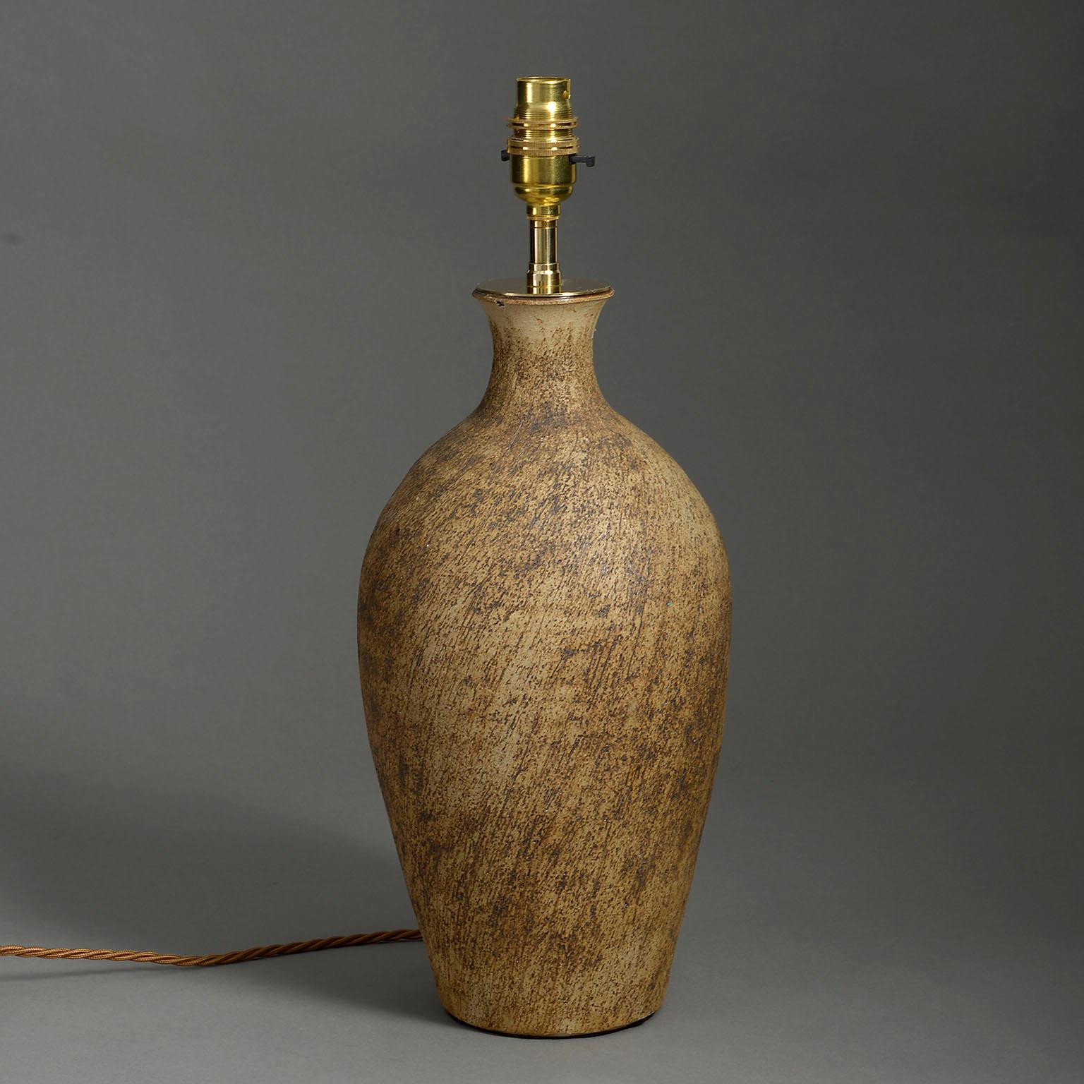 A mid-twentieth century terracotta bottle, with brushed surface, mounted as a lamp base.

Dimensions refer to ceramic part only.

Wired to UK standards. This lamp can be rewired to all international specifications inclusive of price