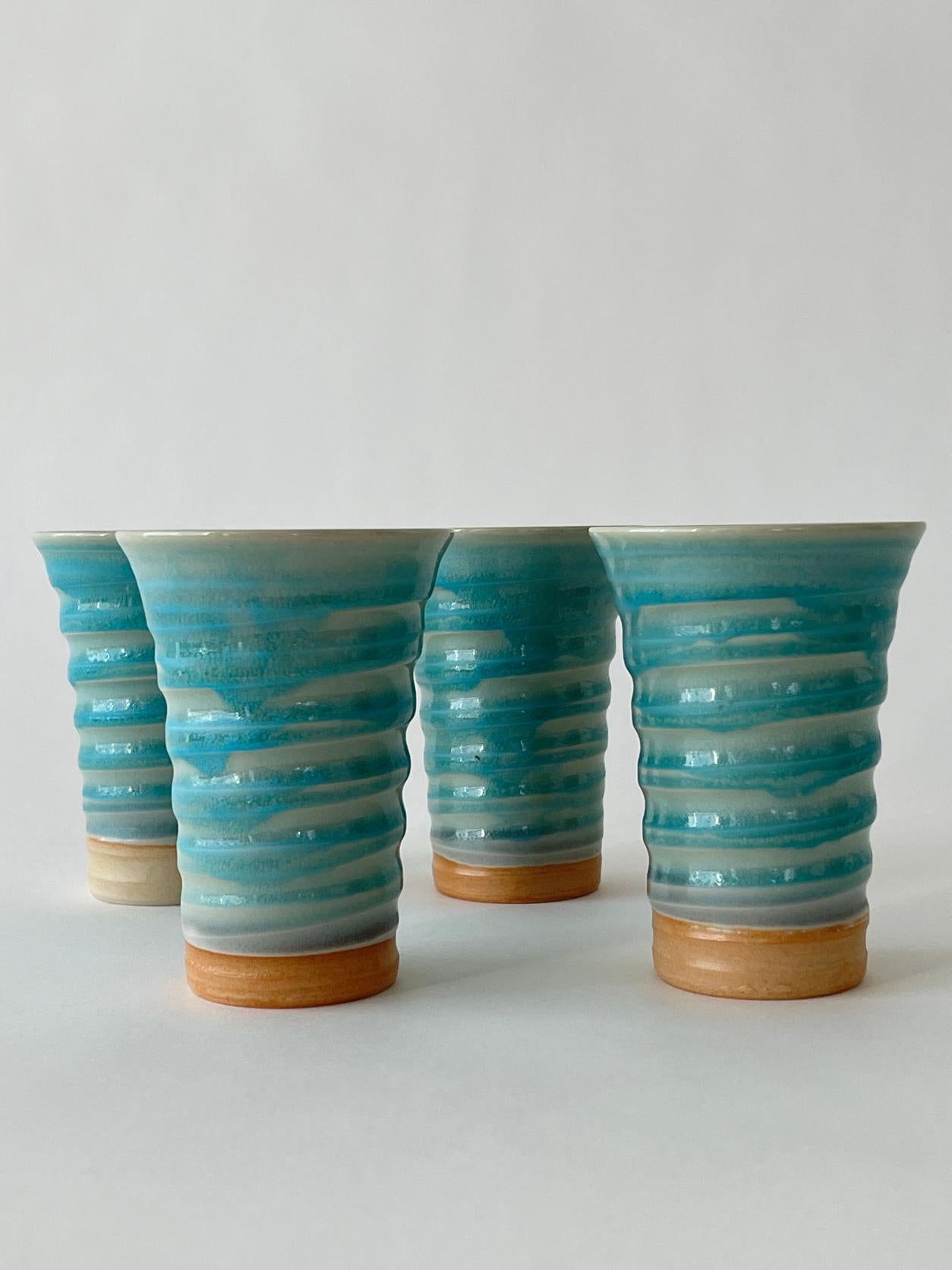 20th century Ceramic ice cream cone glasses in a beautiful baby blue glazed coat and light tan bottom. Ridged sides with a flute opening.

Set of 4
Measures: 3.25