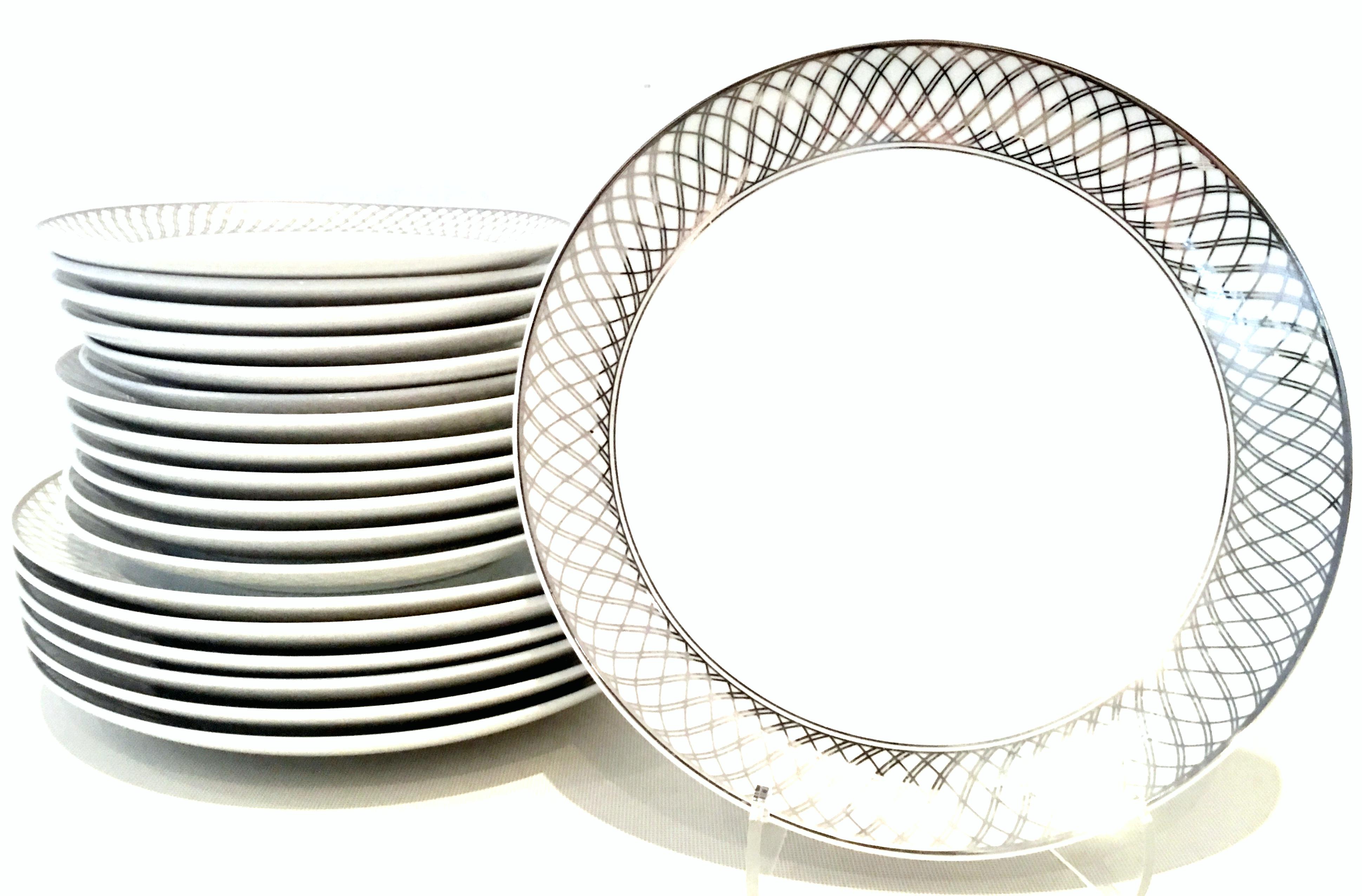 20th Century ceramic and platinum dinnerware set of 18 pieces by, Wessco for United Airlines-First Class Service. This Classic and timeless pattern features a coupe shape, bright white ground with silver platinum geometric basket weave and piping