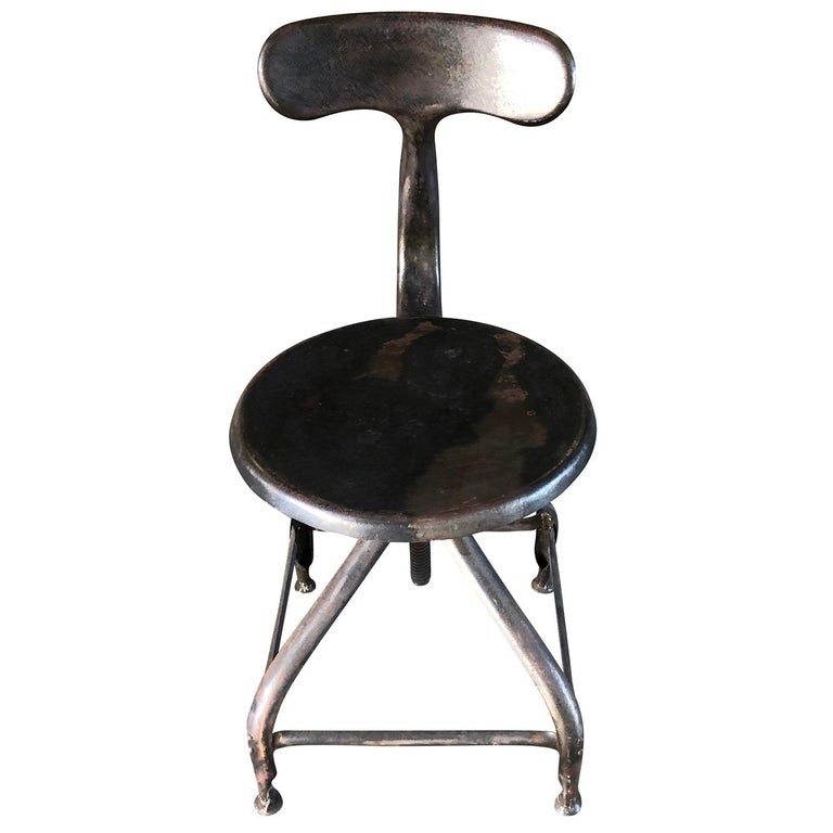 A vintage French Industrial workshop chair made of brushed, waxed metal, the seat height is adjustable. Designed by Paul-Henry Nicolle and produced by NICOLLE, in good condition. Wear consistent with age and use, circa 1930-1940, Paris, France.