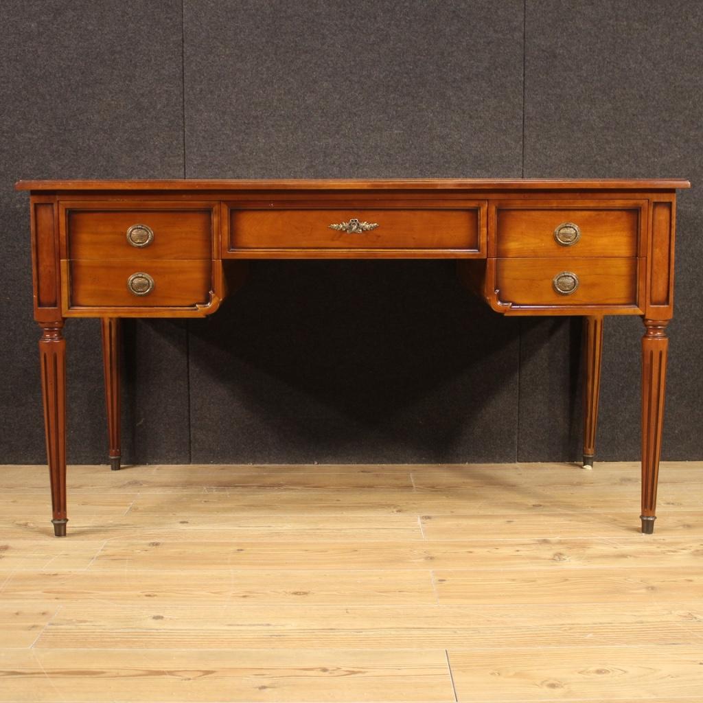 French writing desk from 20th century. Furniture finished from the center carved in cherry, beech and fruitwood. Desk equipped with 5 front drawers, the central one complete with working key. Desk adorned with character top covered in chiseled and