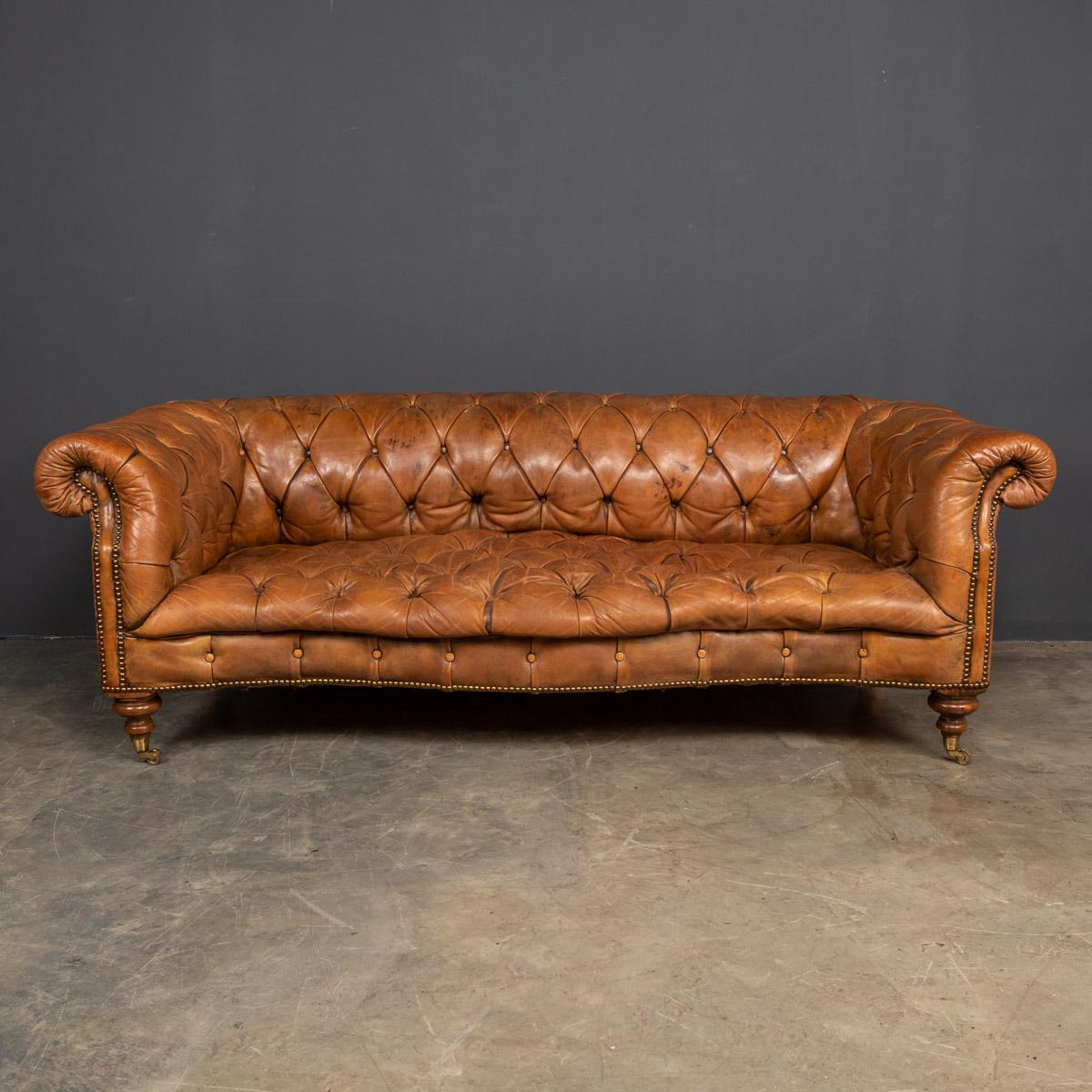 Antique early 20th century Edwardian leather three seater chesterfield sofa. One of the most elegant models with button down seating, turned mahogany legs and brass castors. The Chesterfield sofa remains as fashionable now as it has ever been,