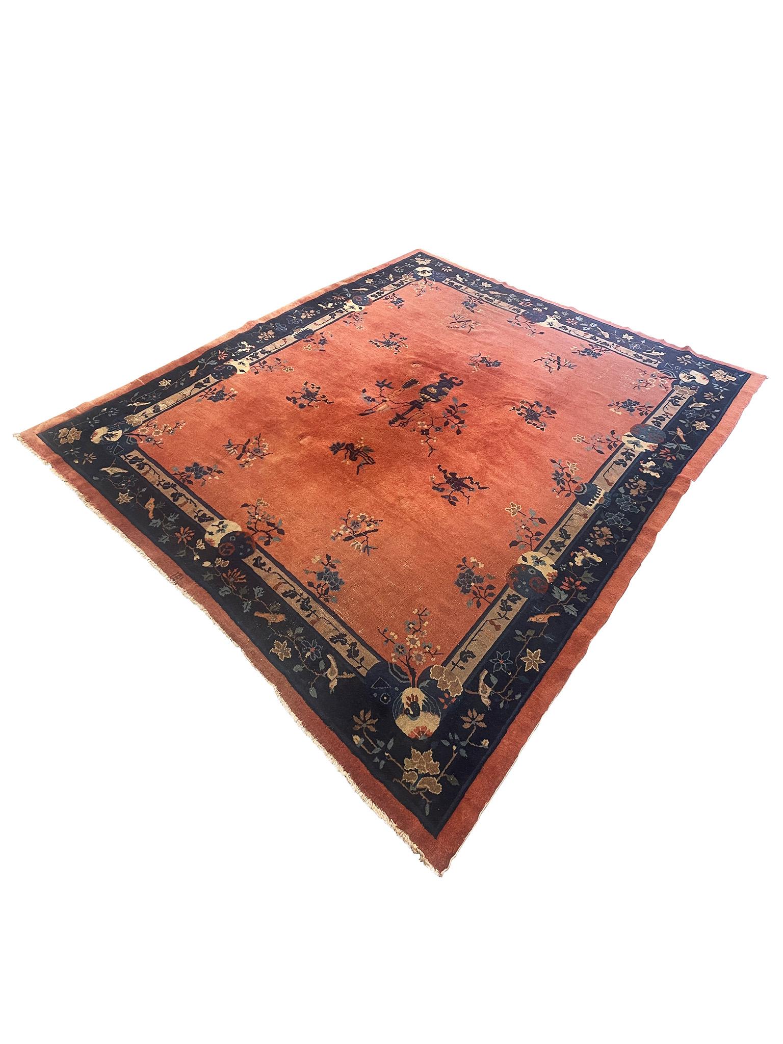 Beautiful low pile 20th century rug, designed with Chinese motifs in the style of Art Deco. Crafted in quintessential Art Deco vibrant hues of navy and rust, this rug features floral, branch, and bird motifs with a depiction of a Chinese-style vase