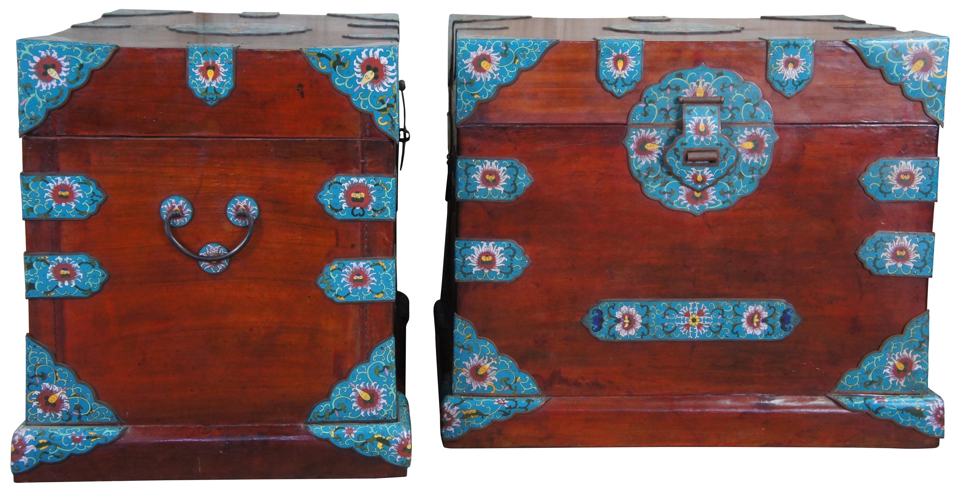 Pair of two 20th century Chinese blanket chests or trunks. Made of Camphor wood bound with ornate cloisonne that features a turquoise field with floral accents. Each containing one tray and iron handles. Purchased in Seattle WA in the