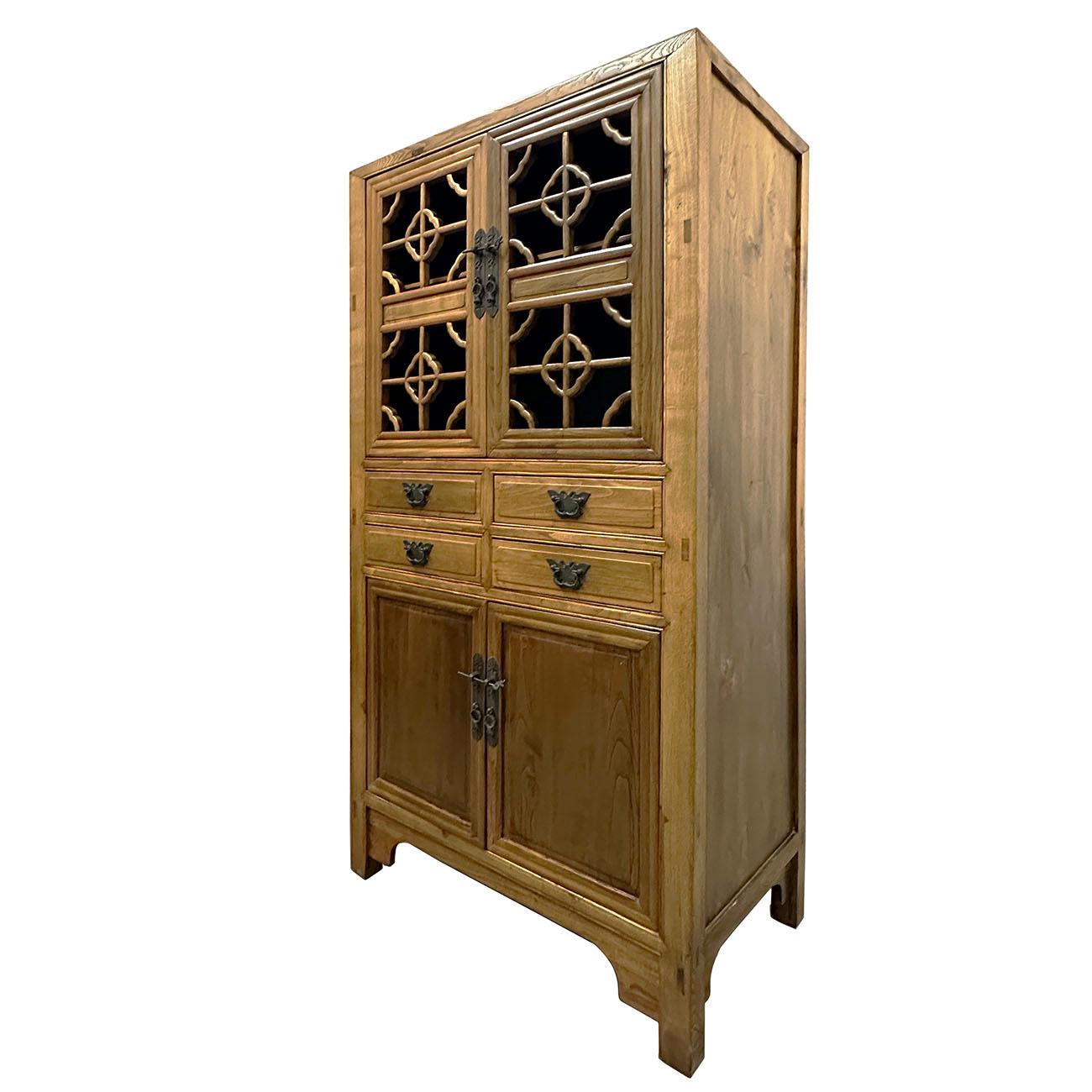 

This Chinese vintage display cabinet from the early 20th century, with carved upper doors and four drawers. Created in China during the early 20th-century period, this display cabinet features a linear silhouette perfectly complimented by a