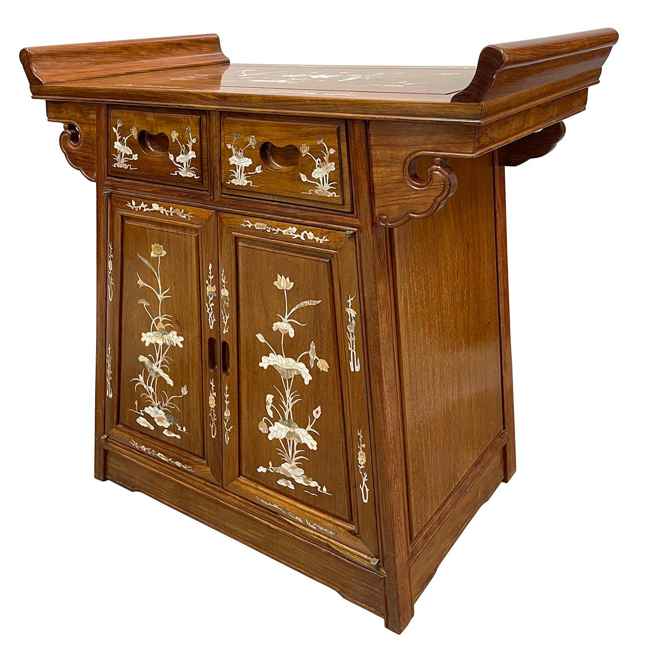 This gorgeous Chinese Antique carved Altar cabinet is made from hardwood with beautiful traditional Mother of pearl inlay of floral design on top and front cabinet. This cabinet has two drawers on the top and double open doors compartment on the