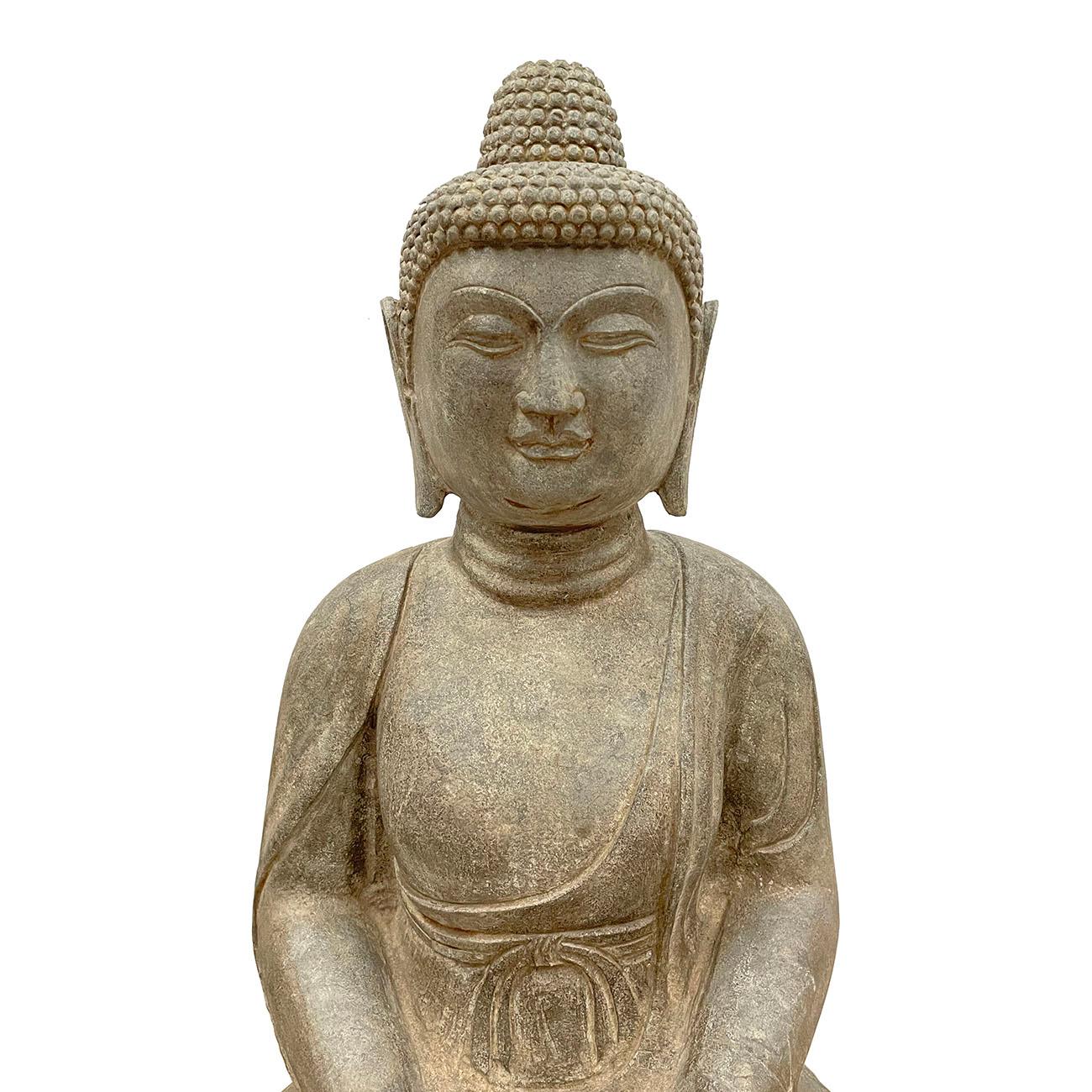 This is a large, finely carved Tang Dynasty style stone statue of Amitabha Sakyamuni Buddha. Below the neatly gathered hair, a full-cheeked face with large eyes, downcast smile and full pursed lips, all flanked by long pendulous earlobes. Buddha