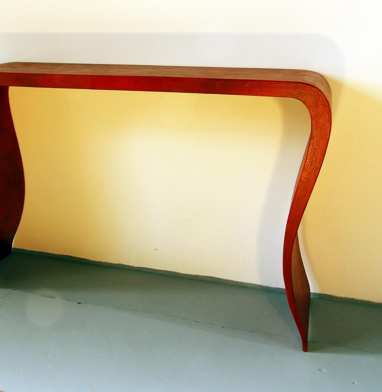 Lacquered 20th century Chinese console table in red lacquered wood.