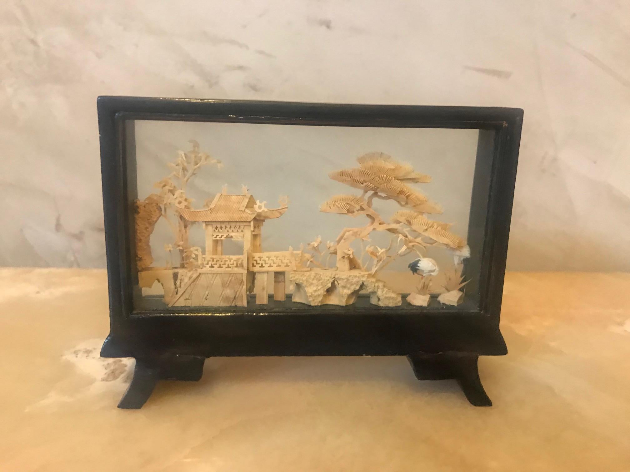 Beautiful 20th century rectangular Chinese Cork diorama.
Finely carved decoration in its glass case and brown lacquered base.
Careful and delicate work of miniature sculpture, representing a Chinese landscape view, a pagoda in a traditional