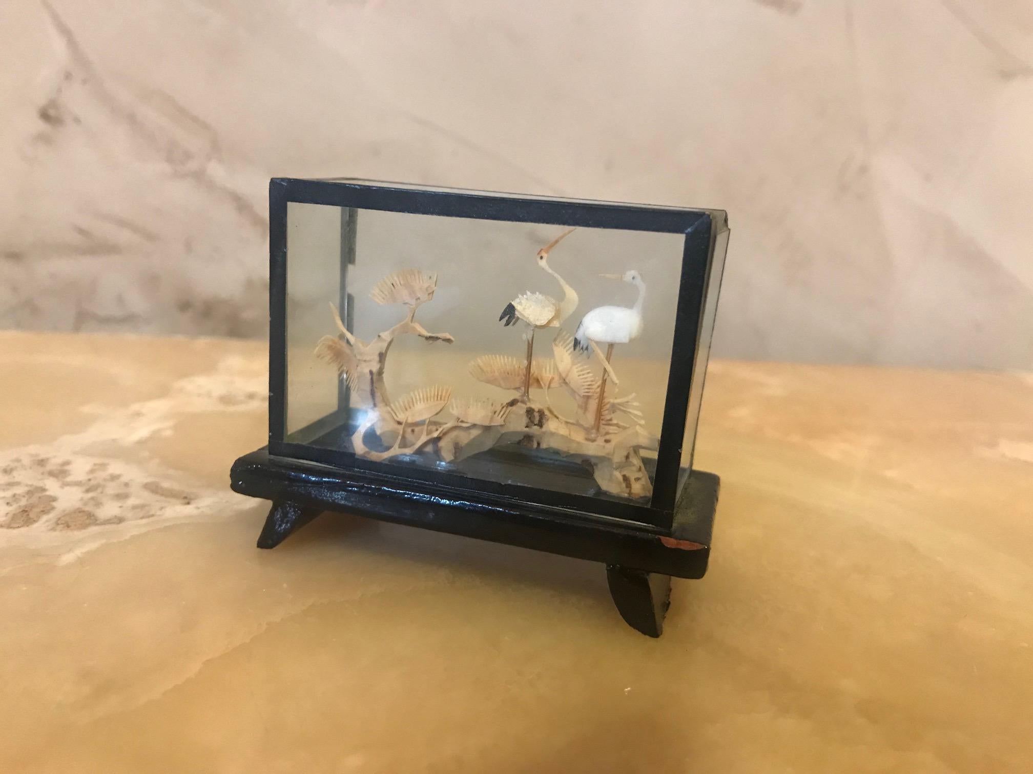 Beautiful 20th century rectangular Chinese Cork diorama.
Finely carved decoration in its glass case and black lacquered base.
Careful and delicate work of miniature sculpture, representing Storks on trees. 
Asian traditional cork sculpture made