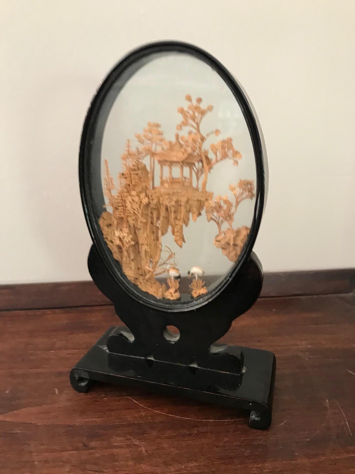 Chinese diorama made of vintage cork in glass and lacquered wood.
Finely carved decoration in its glass case and brown lacquered base.
Careful and delicate work of miniature sculpture, representing a Chinese landscape view, a pagoda in a