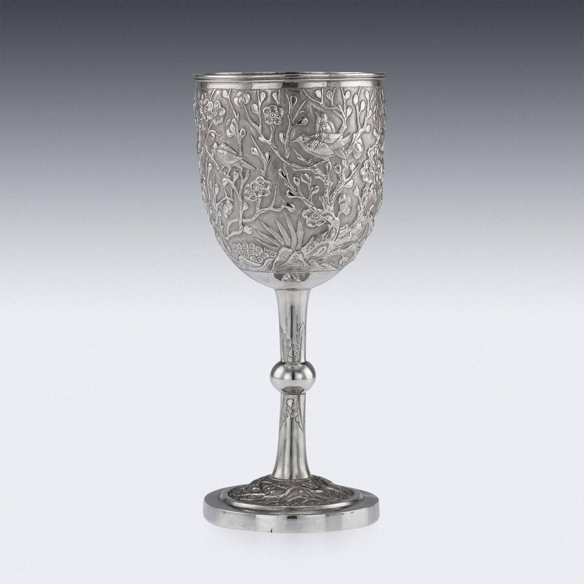 Antique early 20th century Chinese export solid silver presentation wine goblet, impressive and exceptionally fine quality, richly gilt inside, decorated with repoussé prunus and perched birds against a hand chased matted ground, cup resting on an