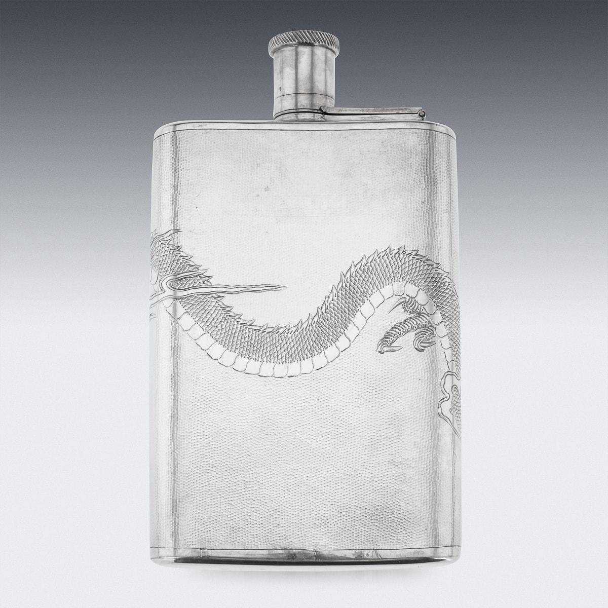 A stunning 20th Century Chinese export solid silver hip flask with silver hinged top. This flask has a textured hammered finish and engraved with a large dragon chasing the pearl of wisfon. Hallmarked 'Silver' (900 standard).

CONDITION
In Great