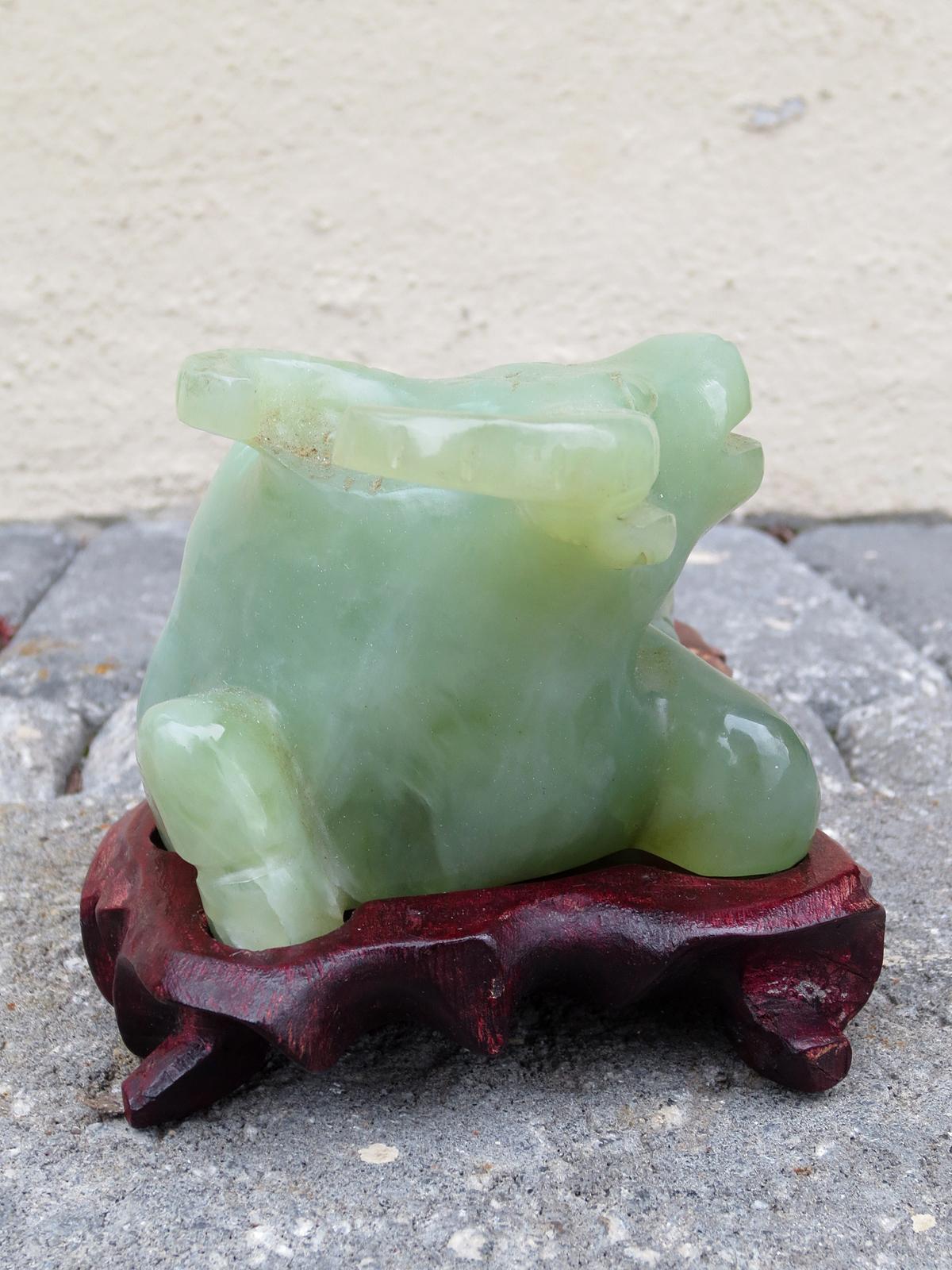 20th century Chinese jade water buffalo on wooden stand.