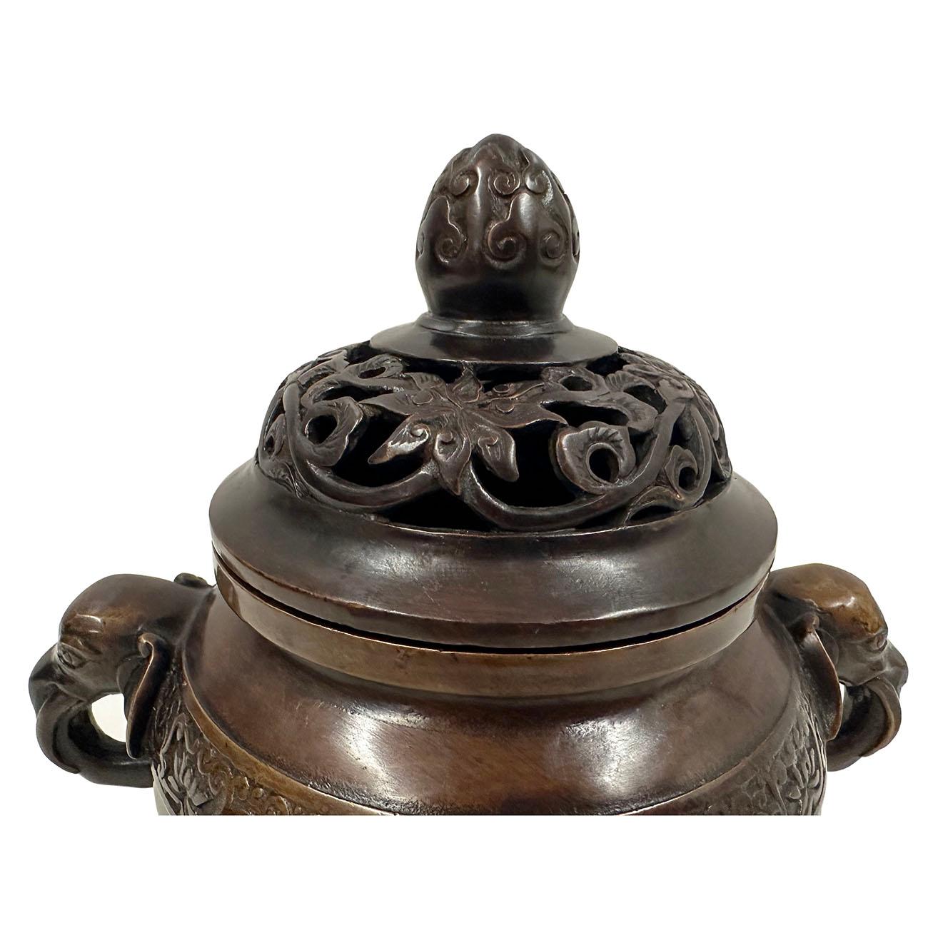 This magnificent Chinese Antique Carved Bronze incense burner has very detailed hand craft works around the body, elephants trunk as legs and handle and lotus bud on the lid of incense burner. It has very detailed art works around it. Open carved