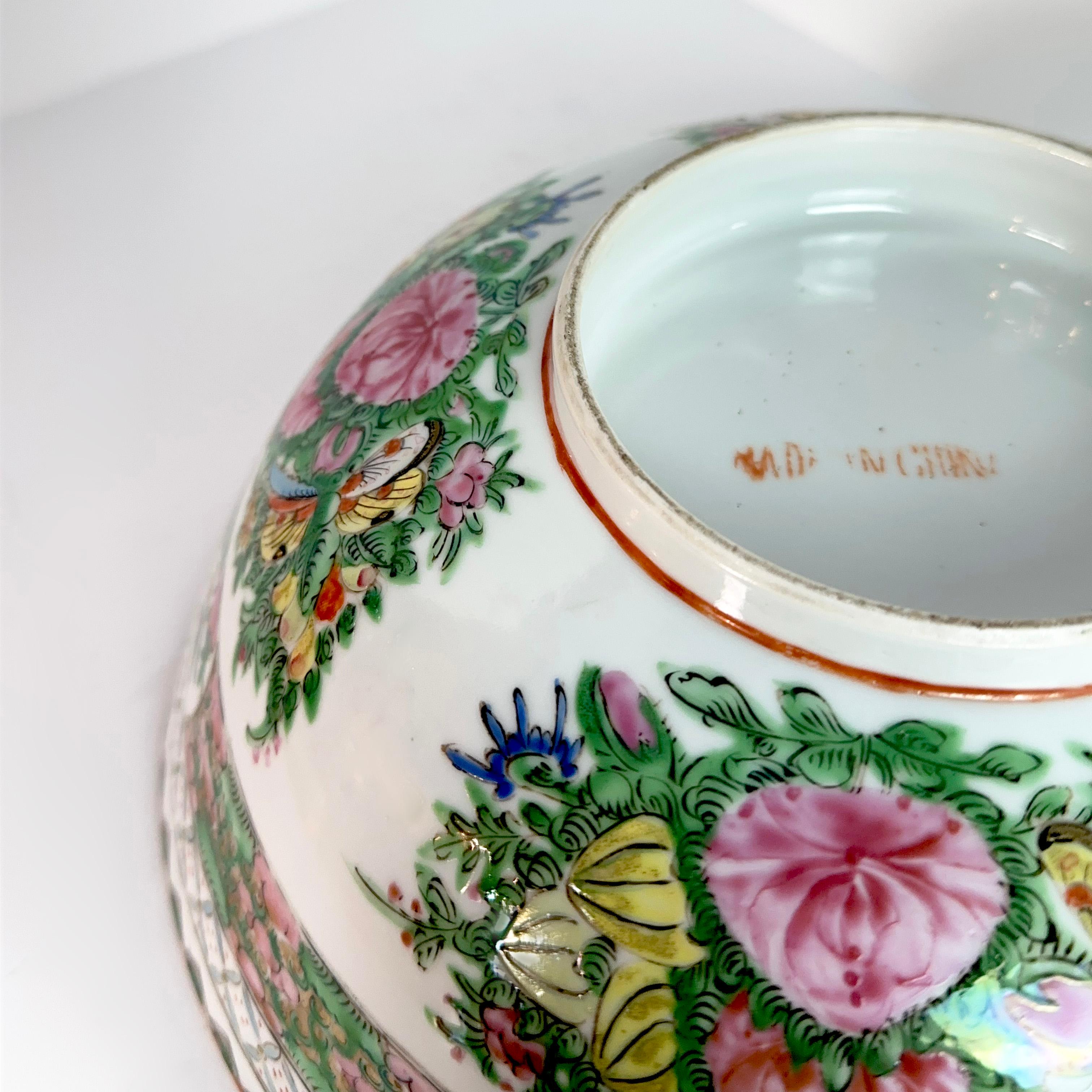 This splendid Chinese porcelain piece, adorned in the vibrant Rose Medallion style, is a large Rose Medallion Canton bowl that will make you embrace the allure of history. The hand-painted enamel finish showcases an intricate scene teeming with lush