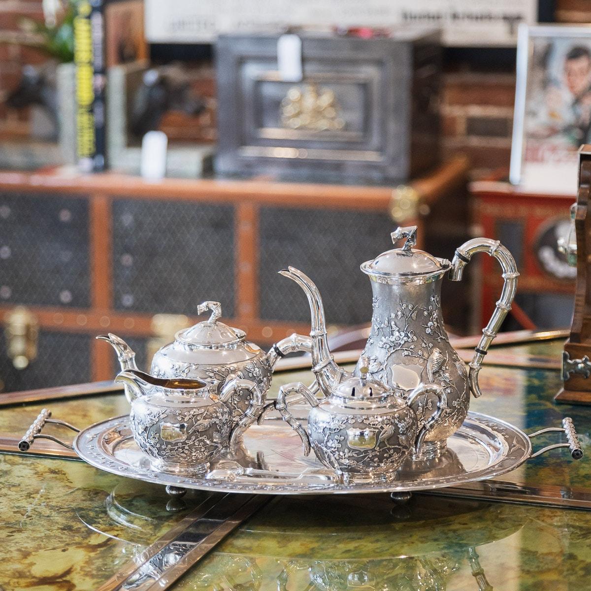 Antique early-20th century Chinese export solid silver exquisite five piece tea set on tray, comprising of a coffee pot, teapot, covered sugar bowl with later plated tongs and milk jug on serving trat, each spherical body applied with blooming